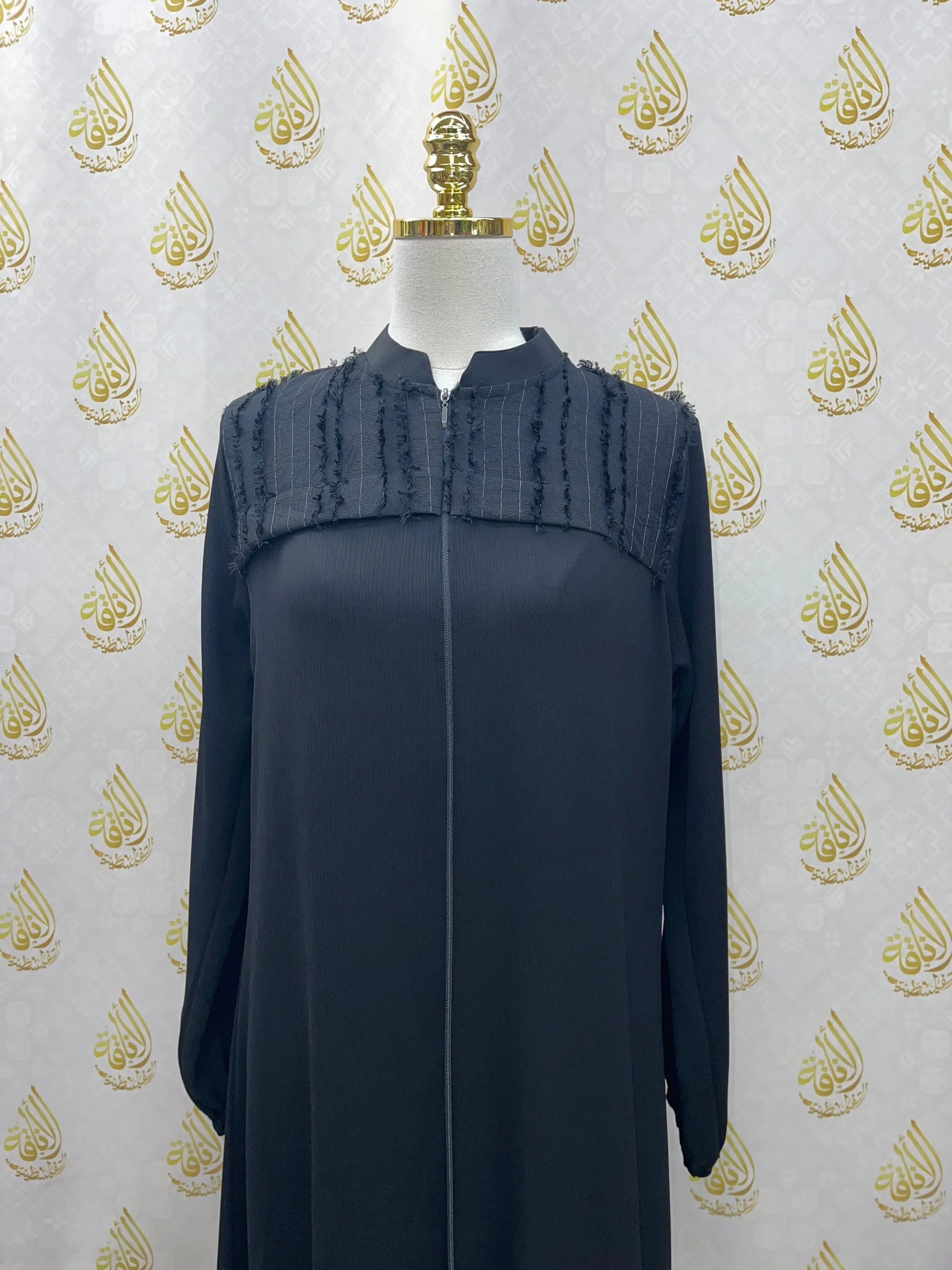 Black casual abaya for women with textured upper detail displayed on mannequin