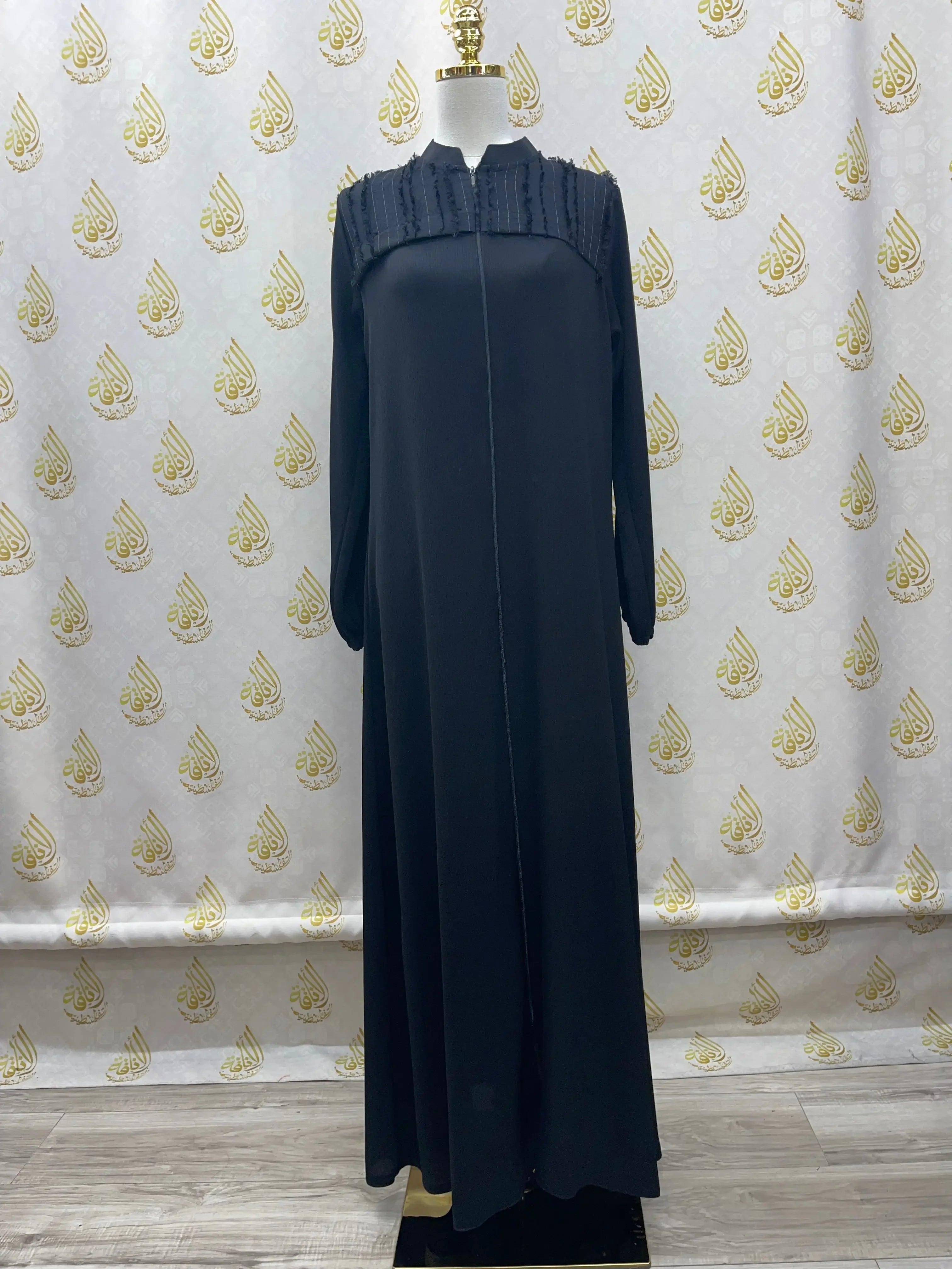 Black casual abaya for women with long sleeves and pleated detailing on shoulders by Palestinian Elegance
