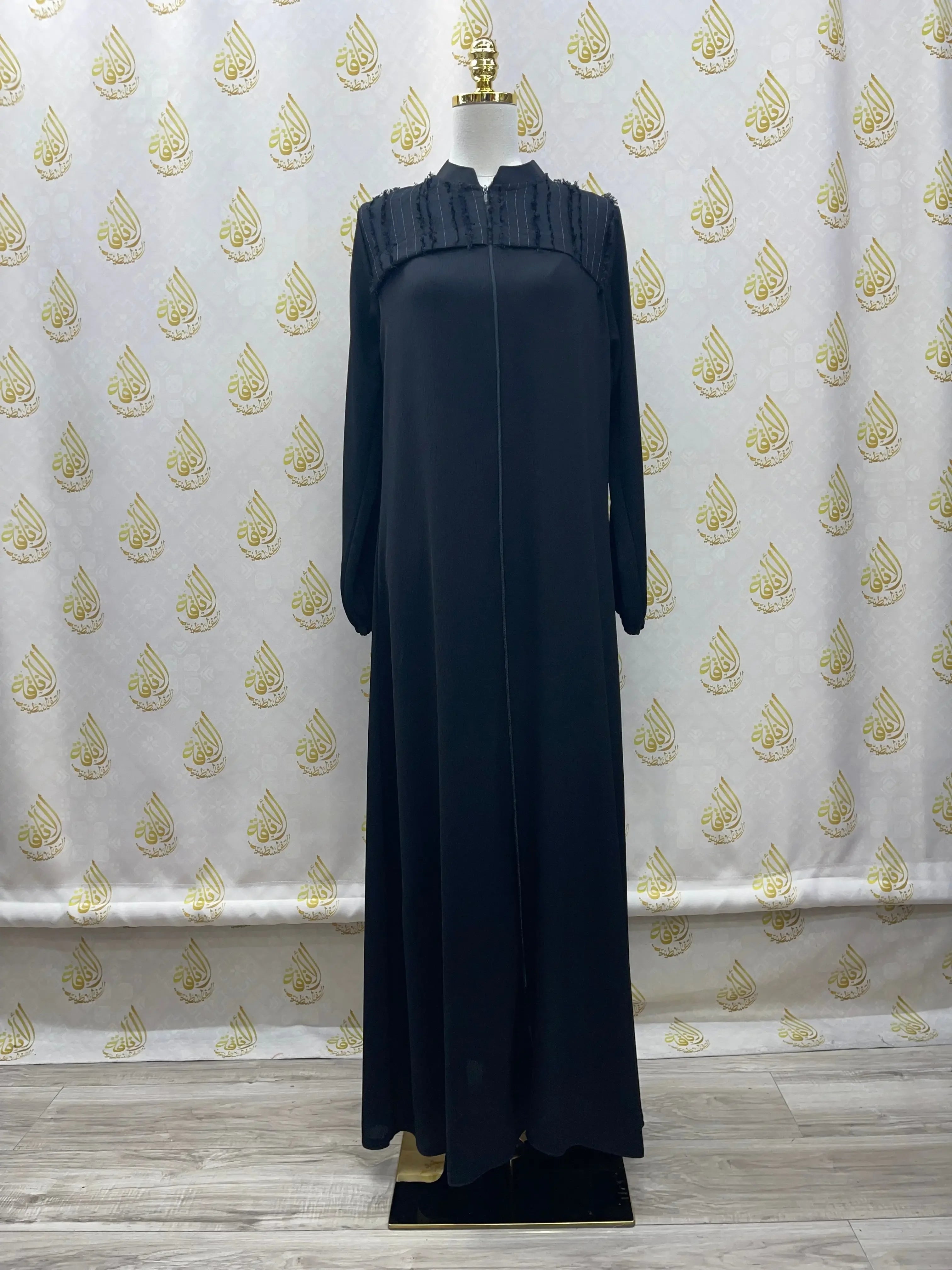 Palestinian Elegance black casual abaya for women with long sleeves and pleated detailing on the chest