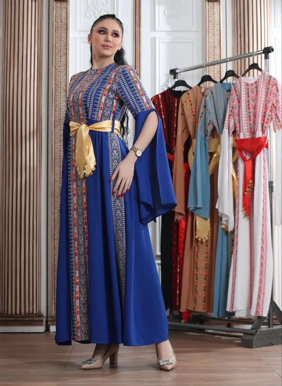 Palestinian Elegance embroidered Manjel dress in blue with intricate patterns and a gold sash belt