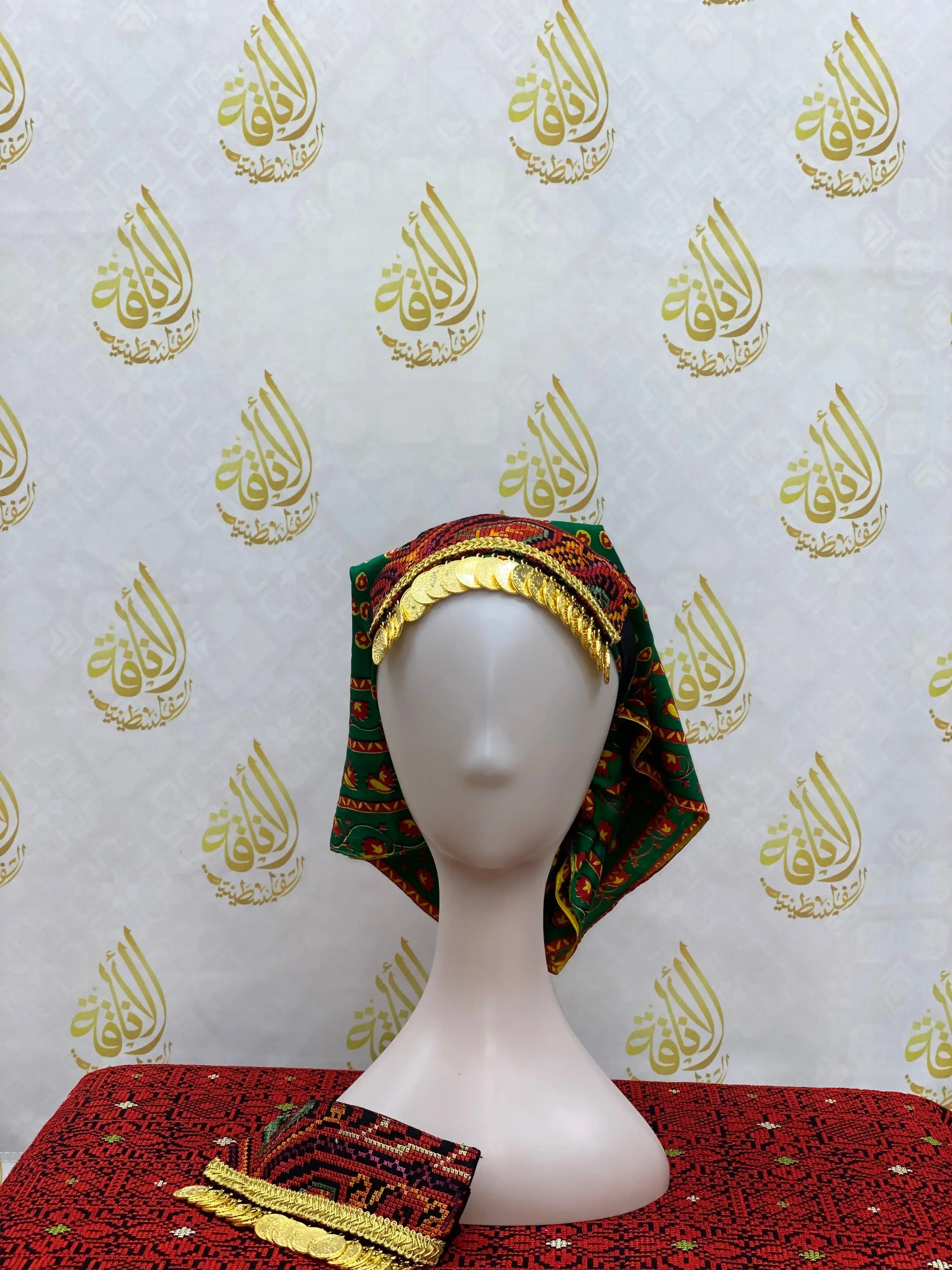 Girls tatreez head scarf with traditional Palestinian embroidery and gold coin decoration displayed on a mannequin