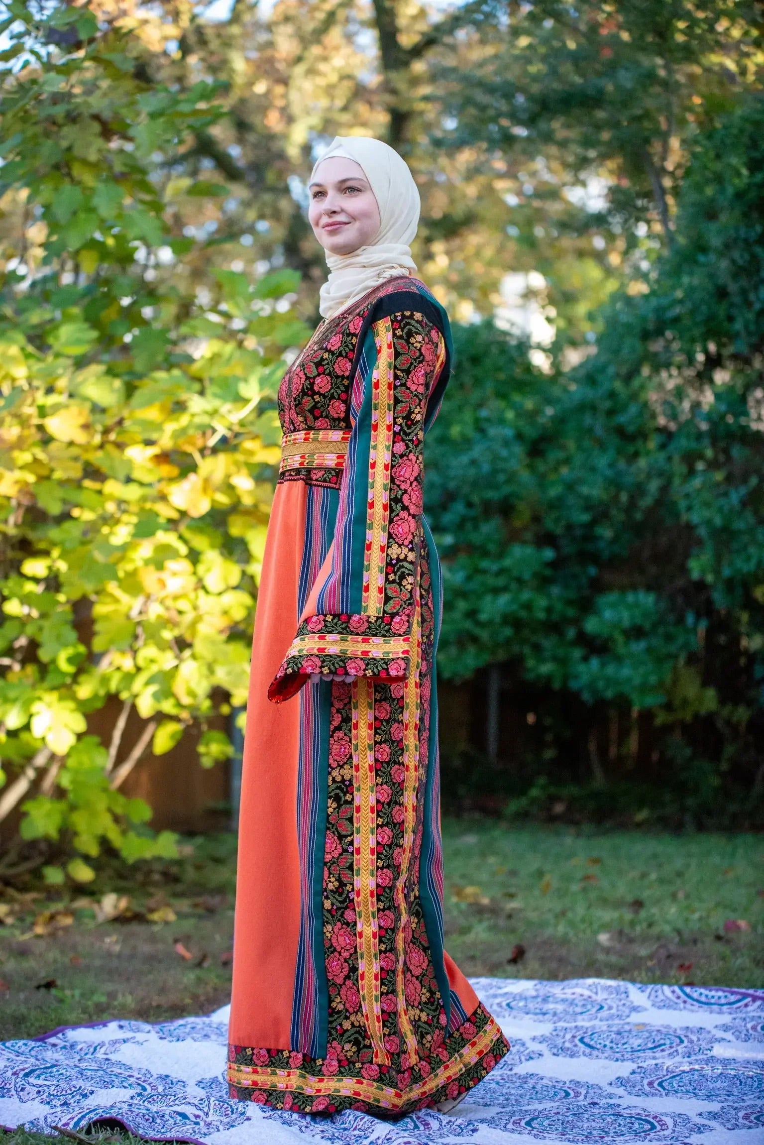 Woman wearing Brown Velvet Orange Majdlawi Thoub embroidery dress with floral patterns outdoors