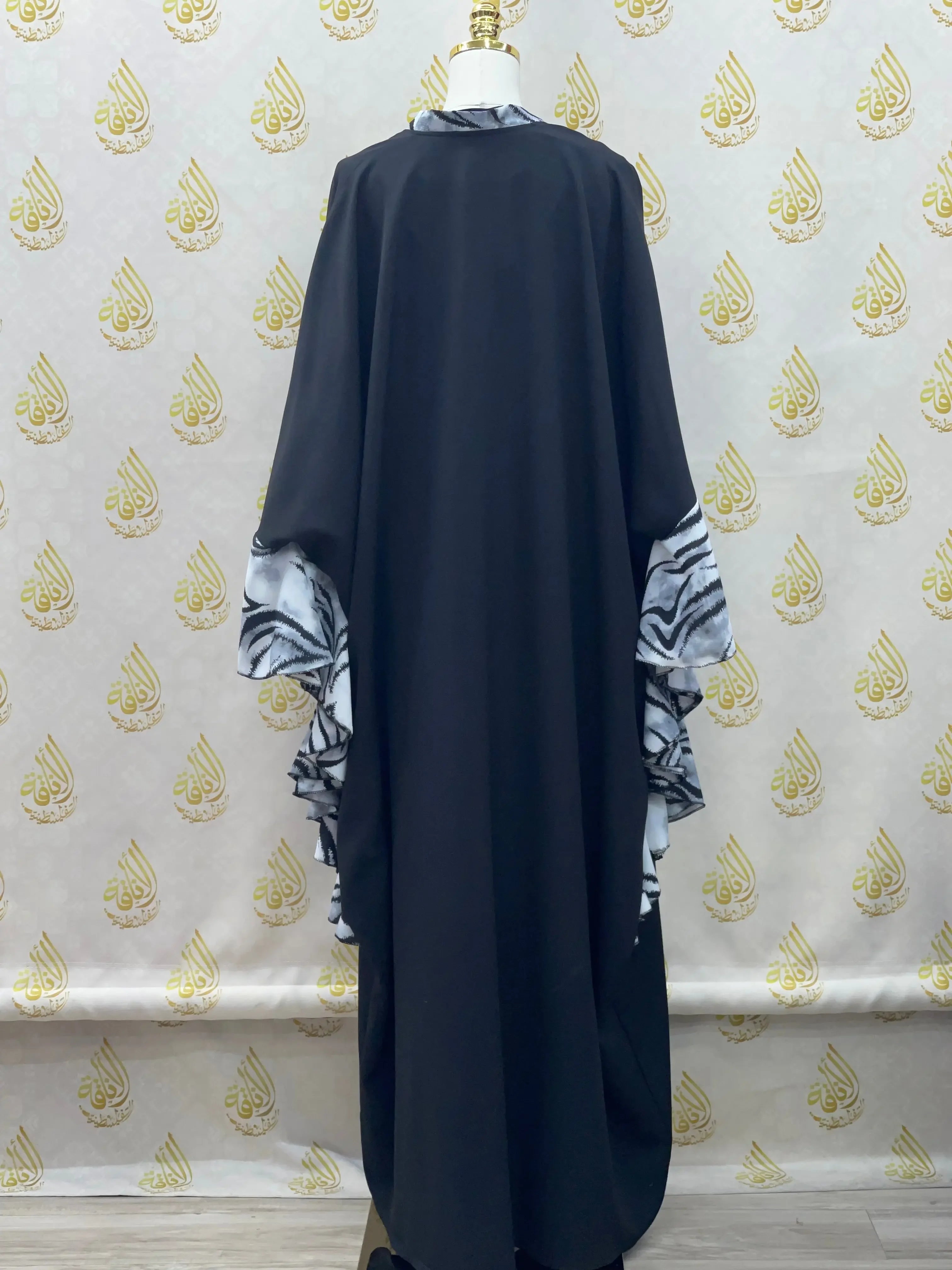 Palestinian Elegance black butterfly abaya dress with patterned inner sleeves and flowing design