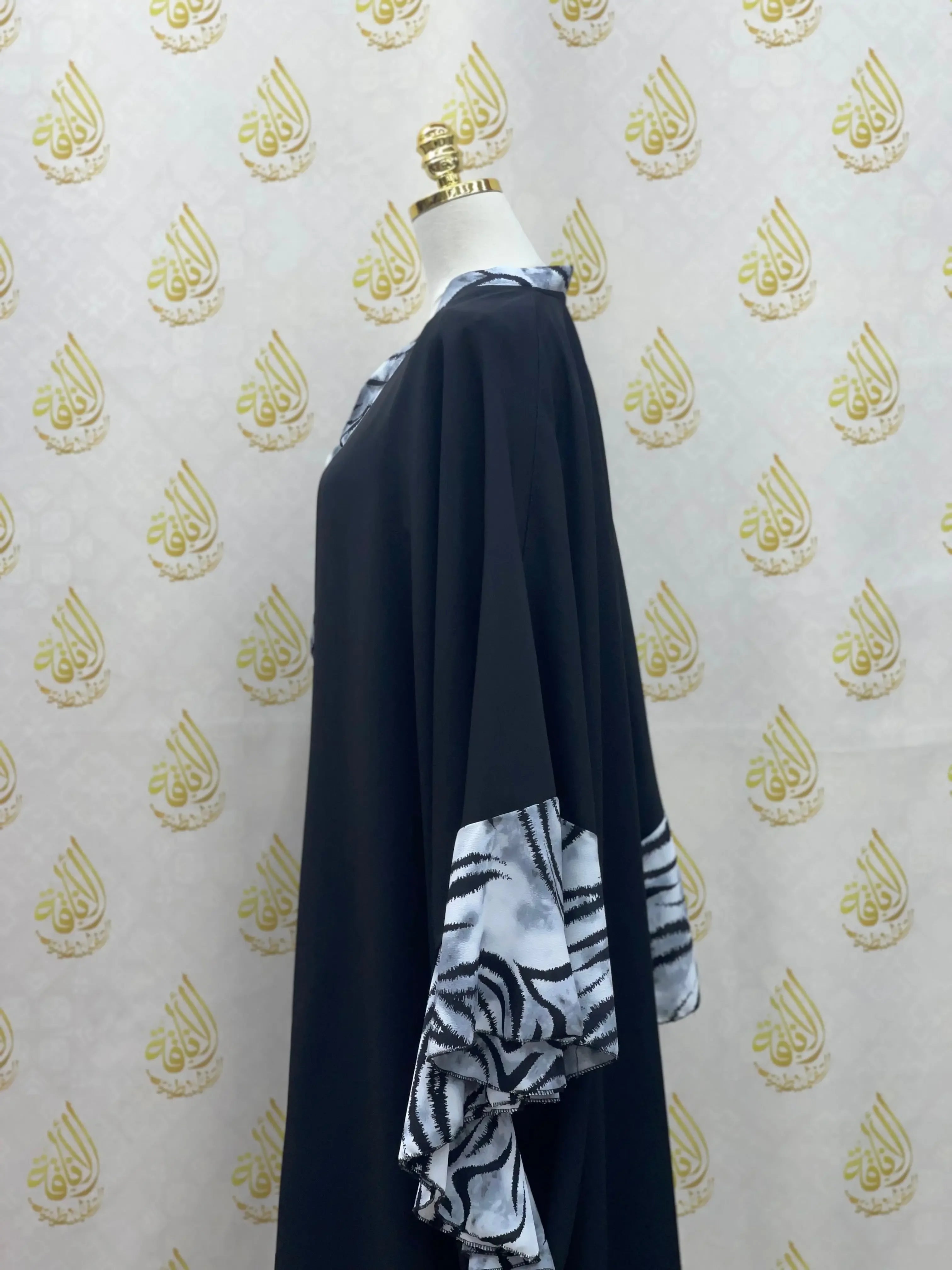 Palestinian Elegance black butterfly abaya dress with white and black patterned sleeve details