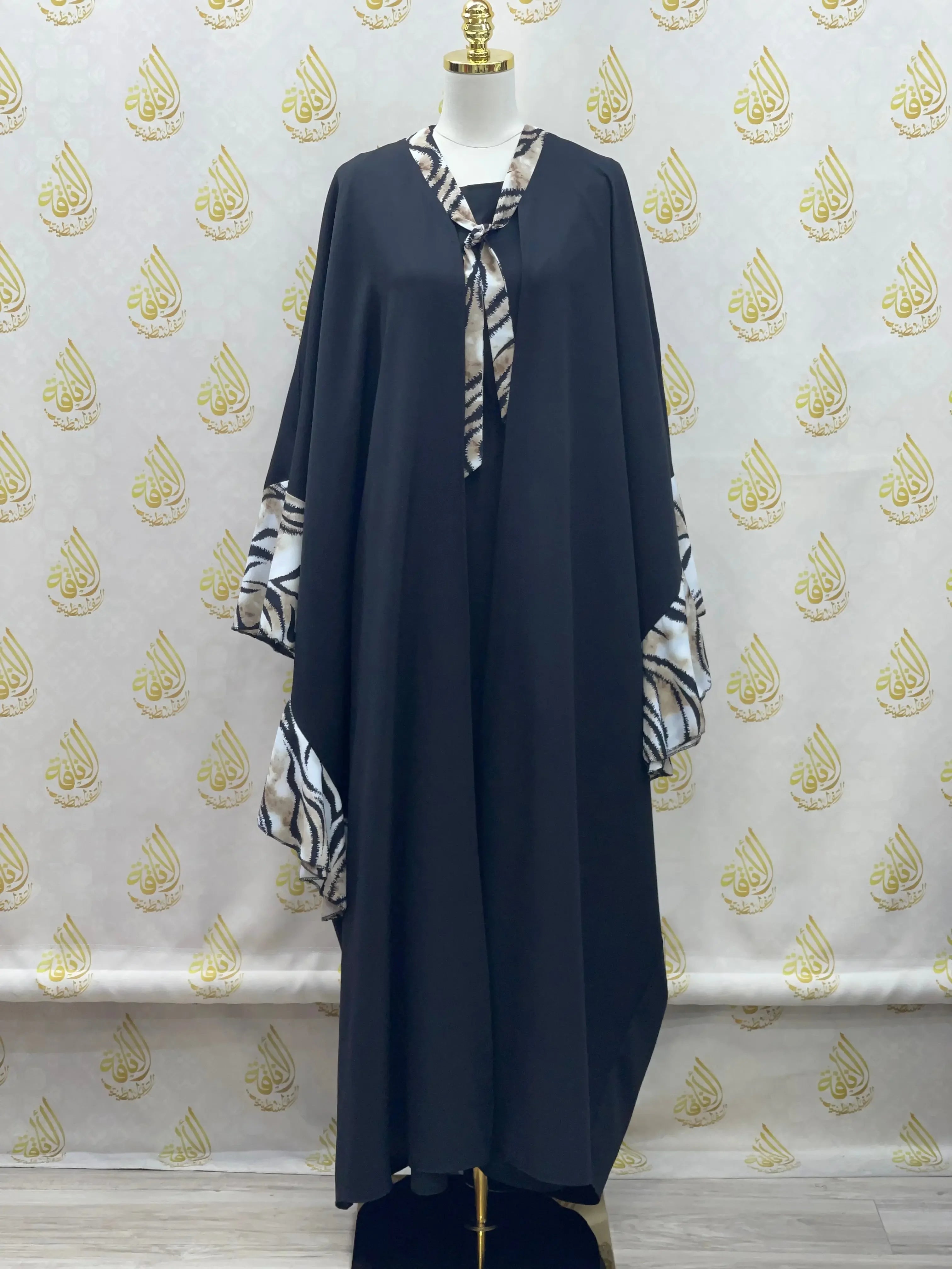 Palestinian Elegance black butterfly abaya dress with patterned cuffs and neck tie detail