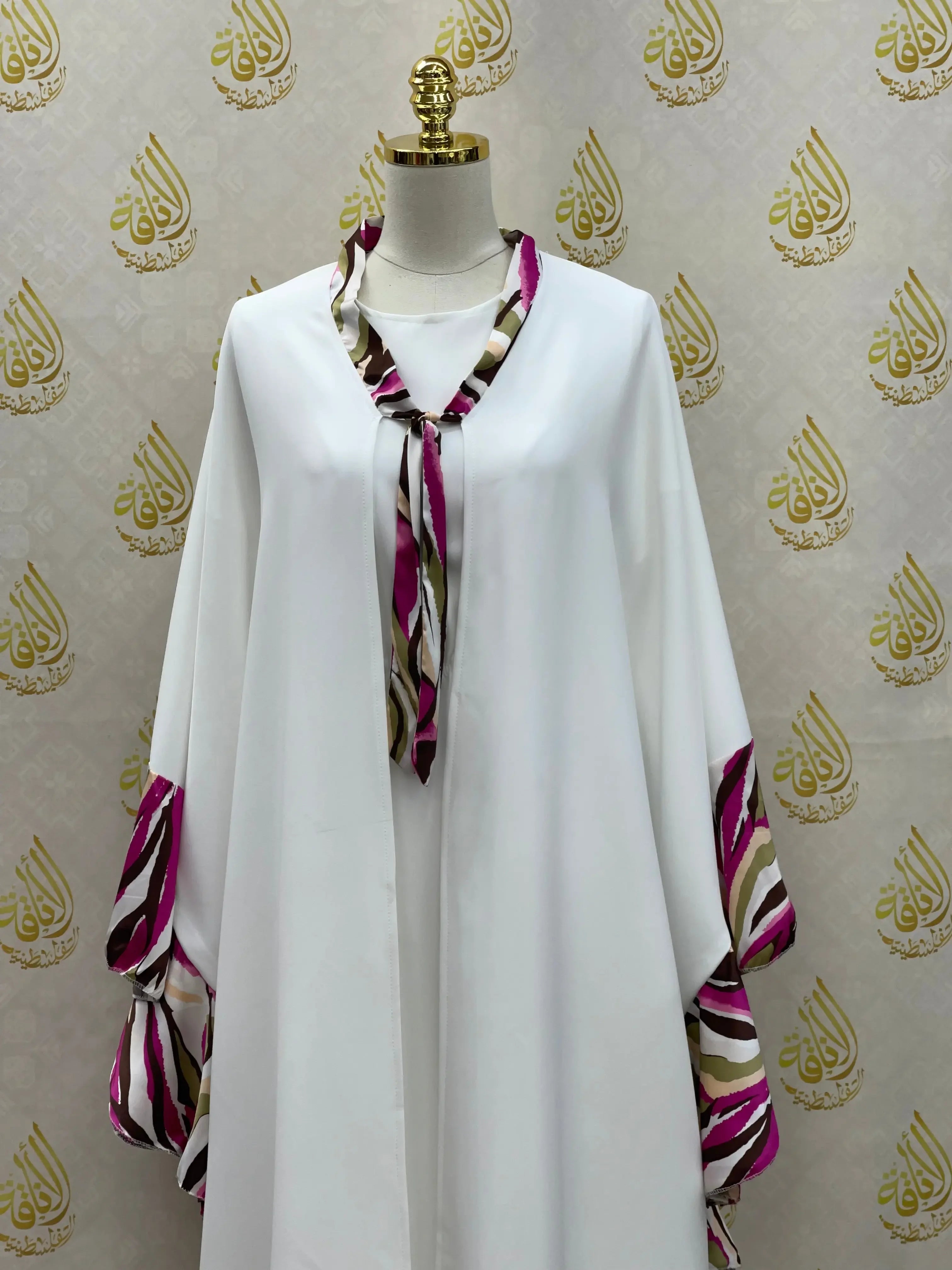 Palestinian Elegance white butterfly abaya dress with purple and beige patterned trim on neckline and sleeves