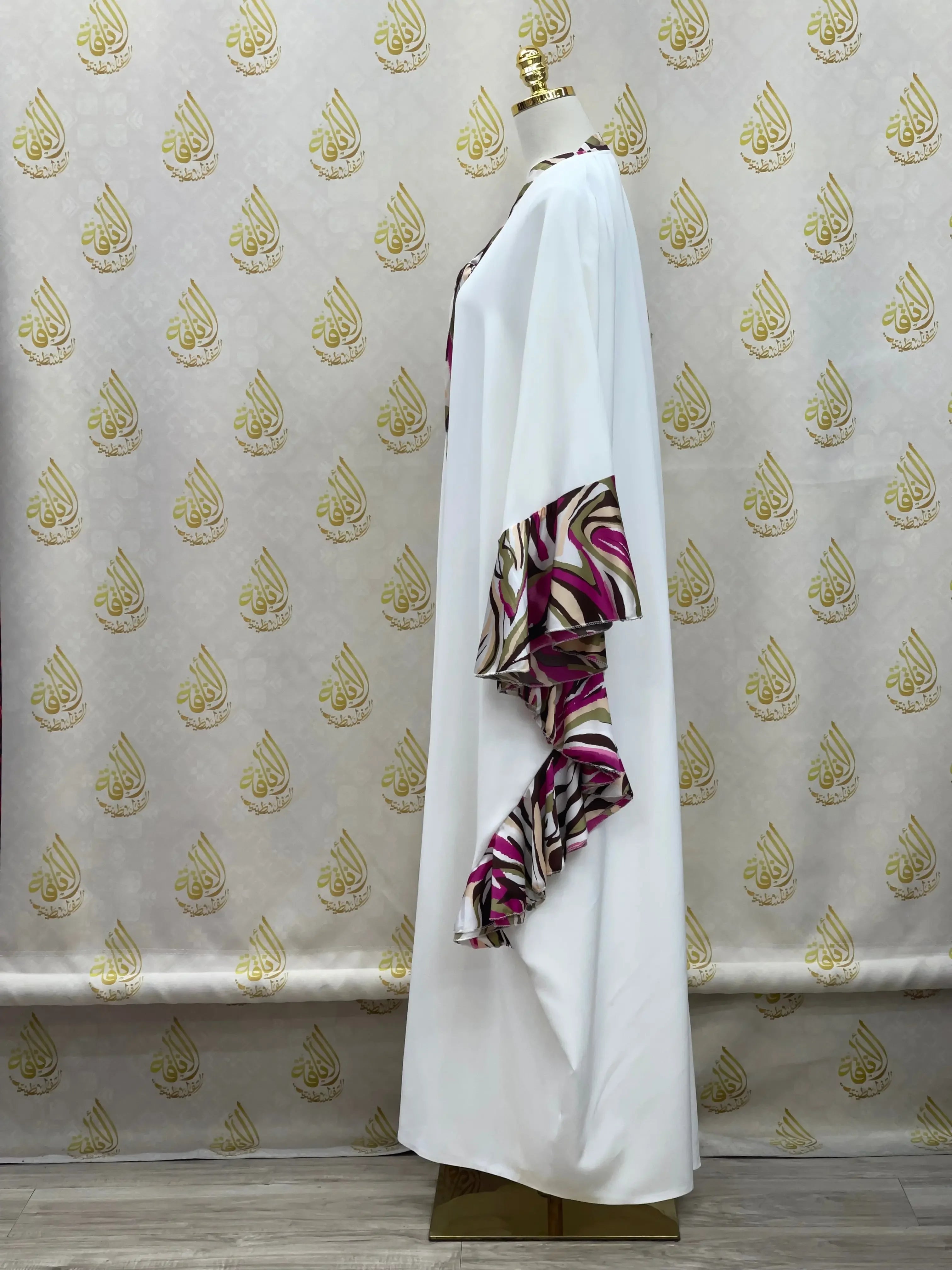 White butterfly abaya dress with purple and brown patterned ruffle sleeves by Palestinian Elegance