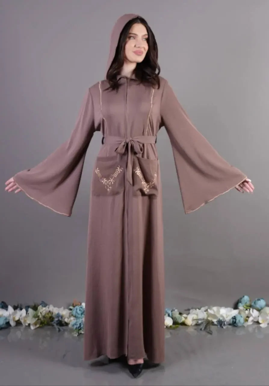 Palestinian Elegance chic pocket abaya in muted mauve with flared sleeves and hooded design