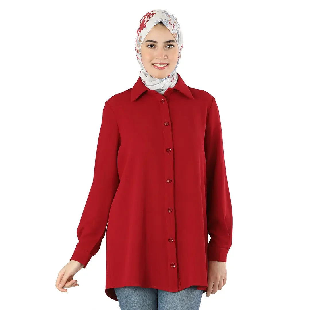 Palestinian Elegance classic button up shirt in red worn with a floral hijab and blue jeans