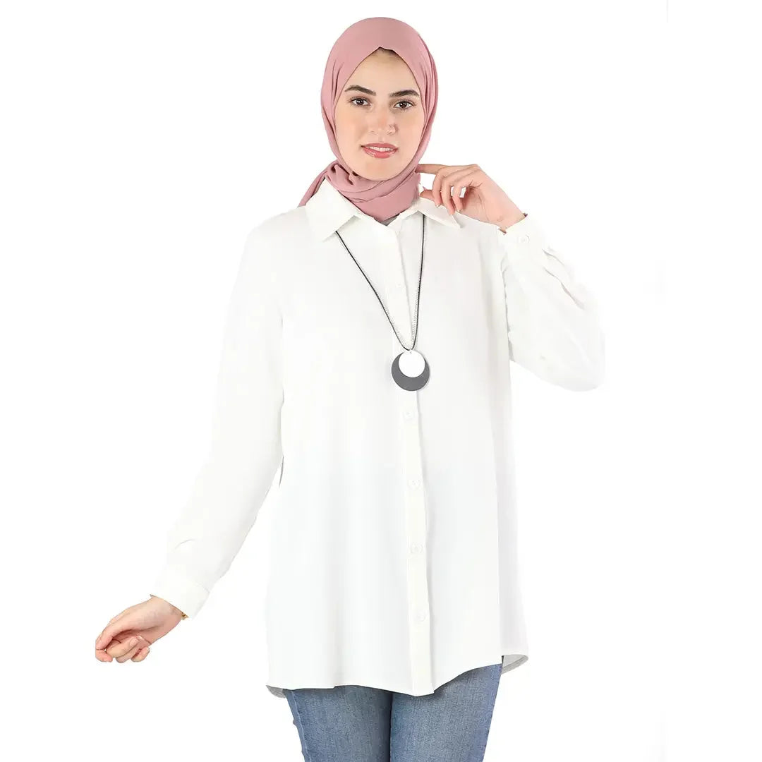 Palestinian Elegance classic button up shirt in white worn with jeans and a pink hijab