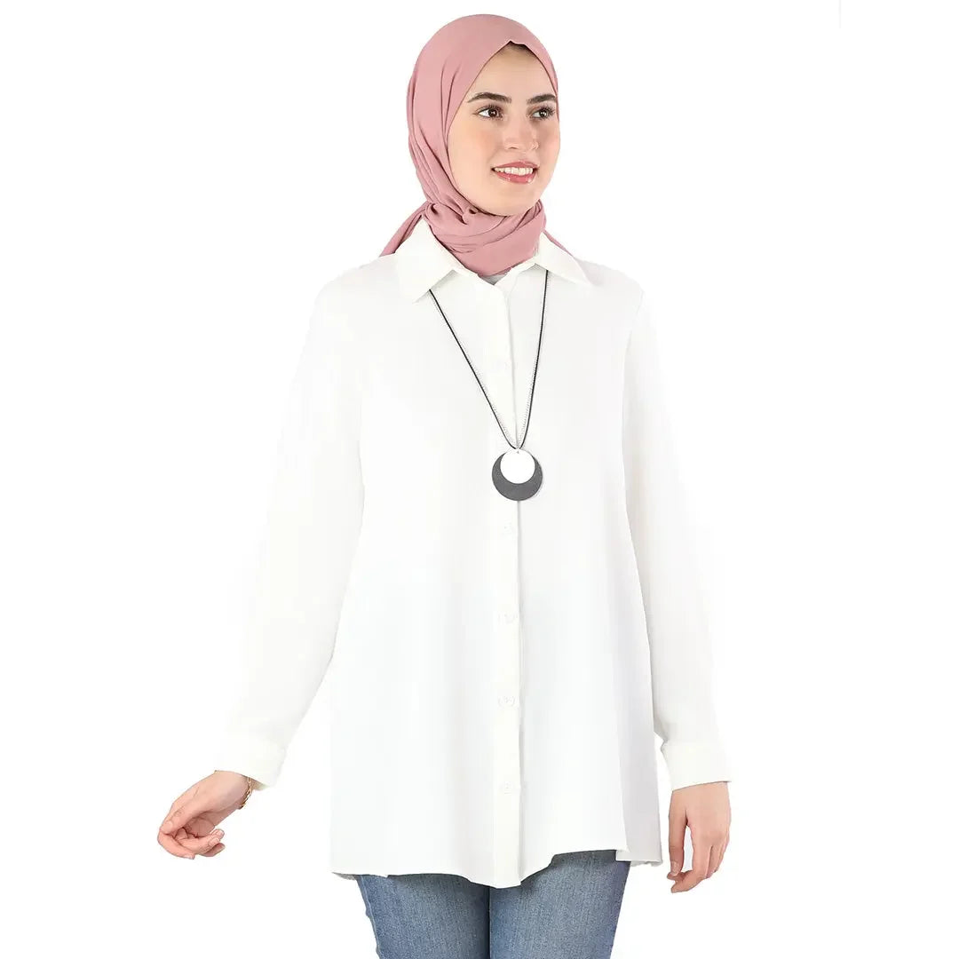 Palestinian Elegance classic button up shirt in white worn with a pink hijab and pendant necklace