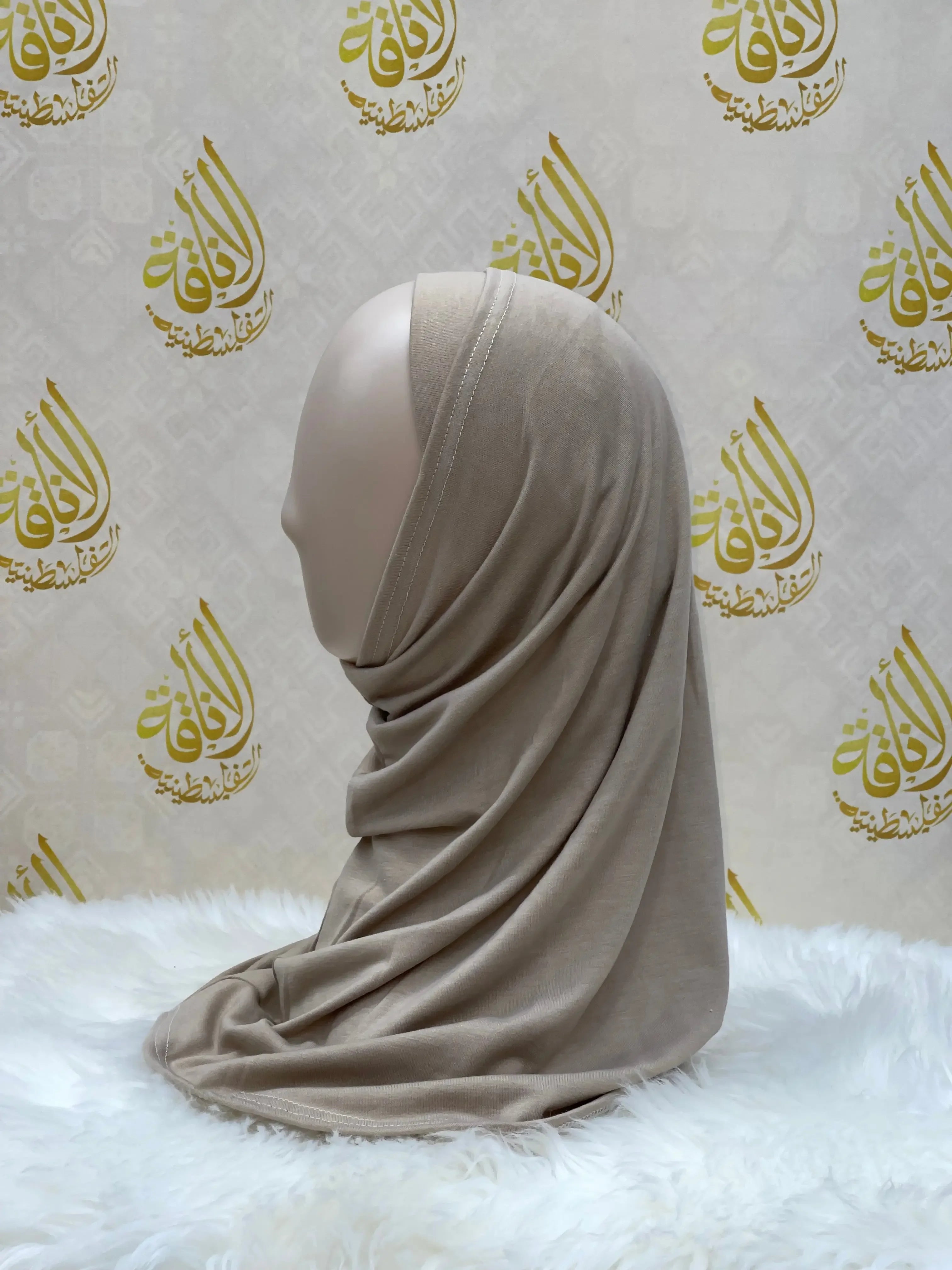 Palestinian Elegance beige cotton hijab for women draped on mannequin against branded backdrop