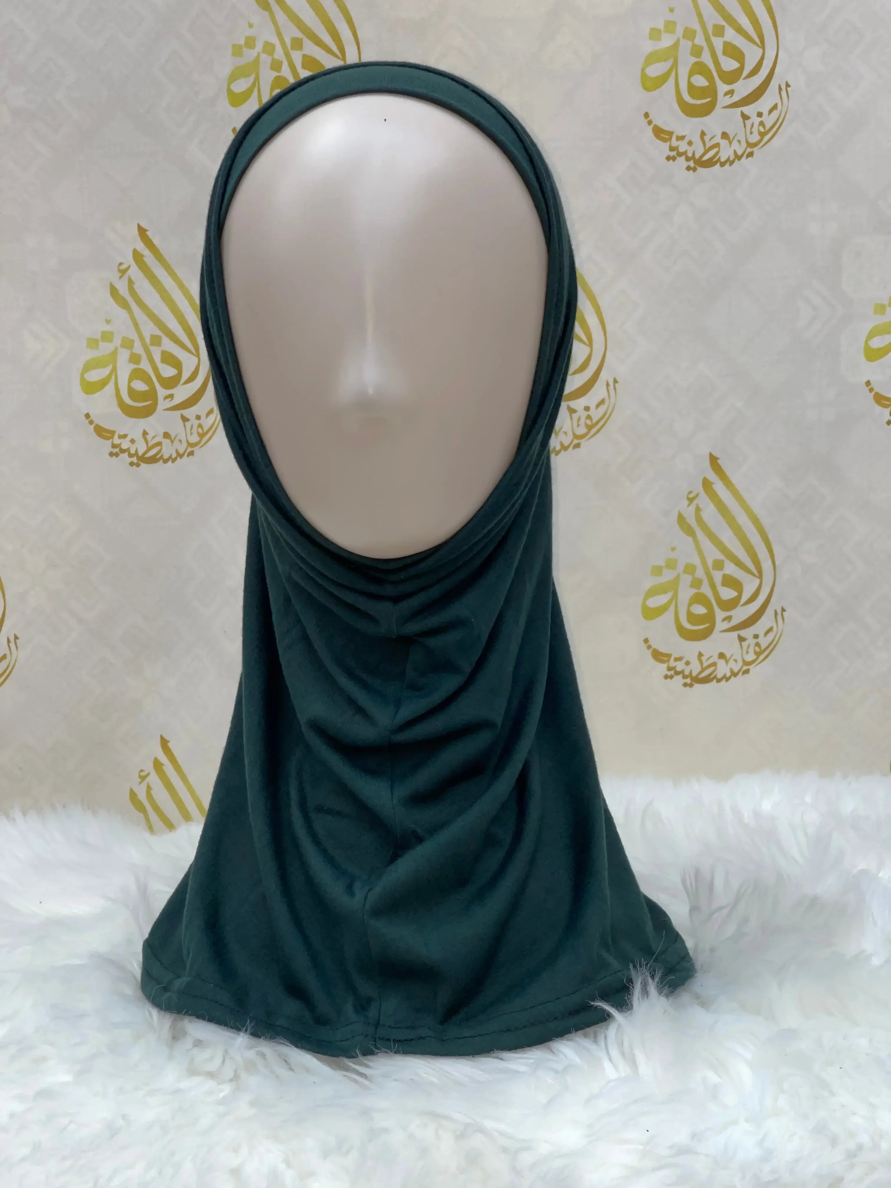 Palestinian Elegance dark green cotton hijab for women displayed on mannequin head