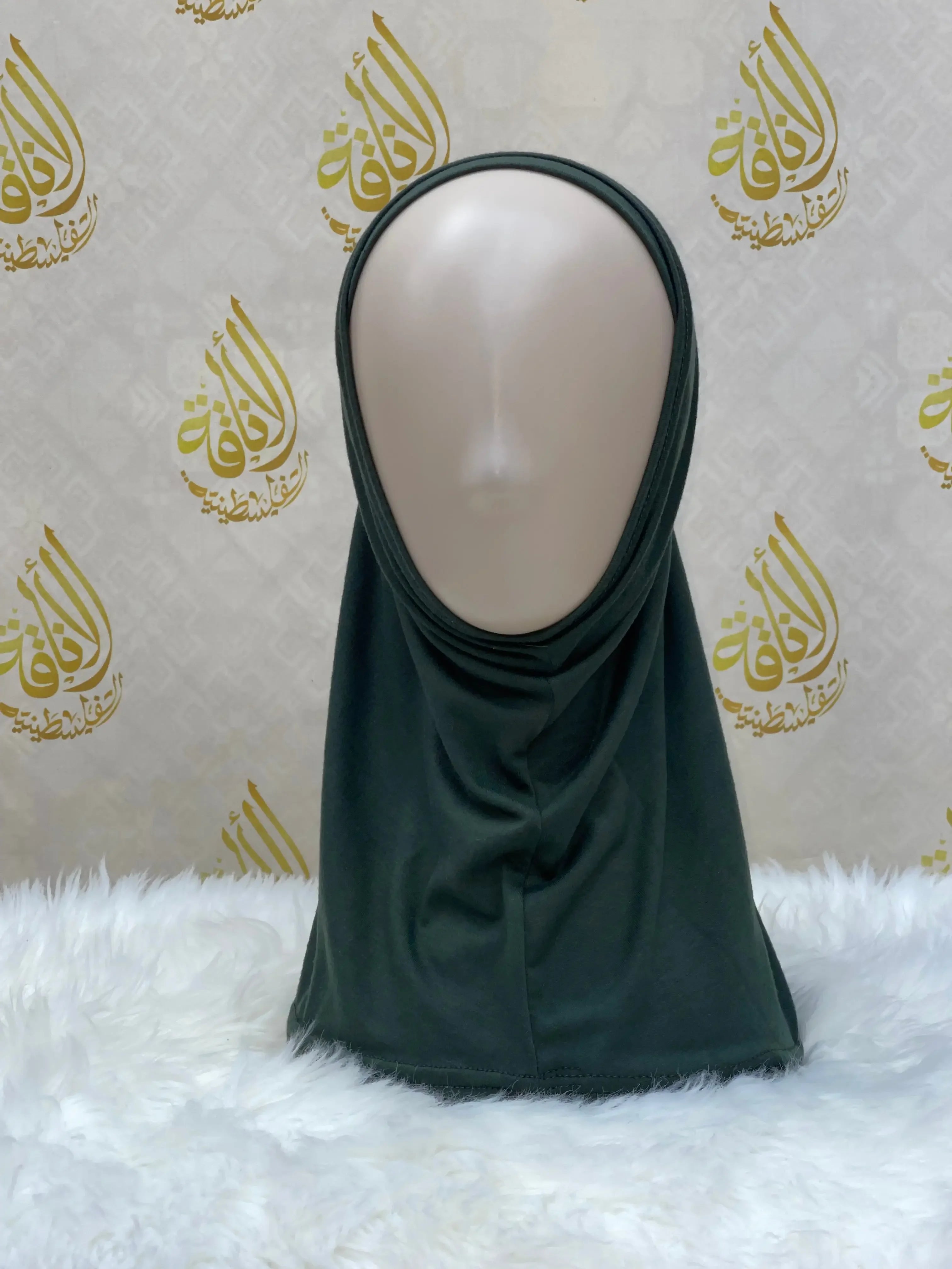 Palestinian Elegance black cotton hijab for women displayed on mannequin with white fur background