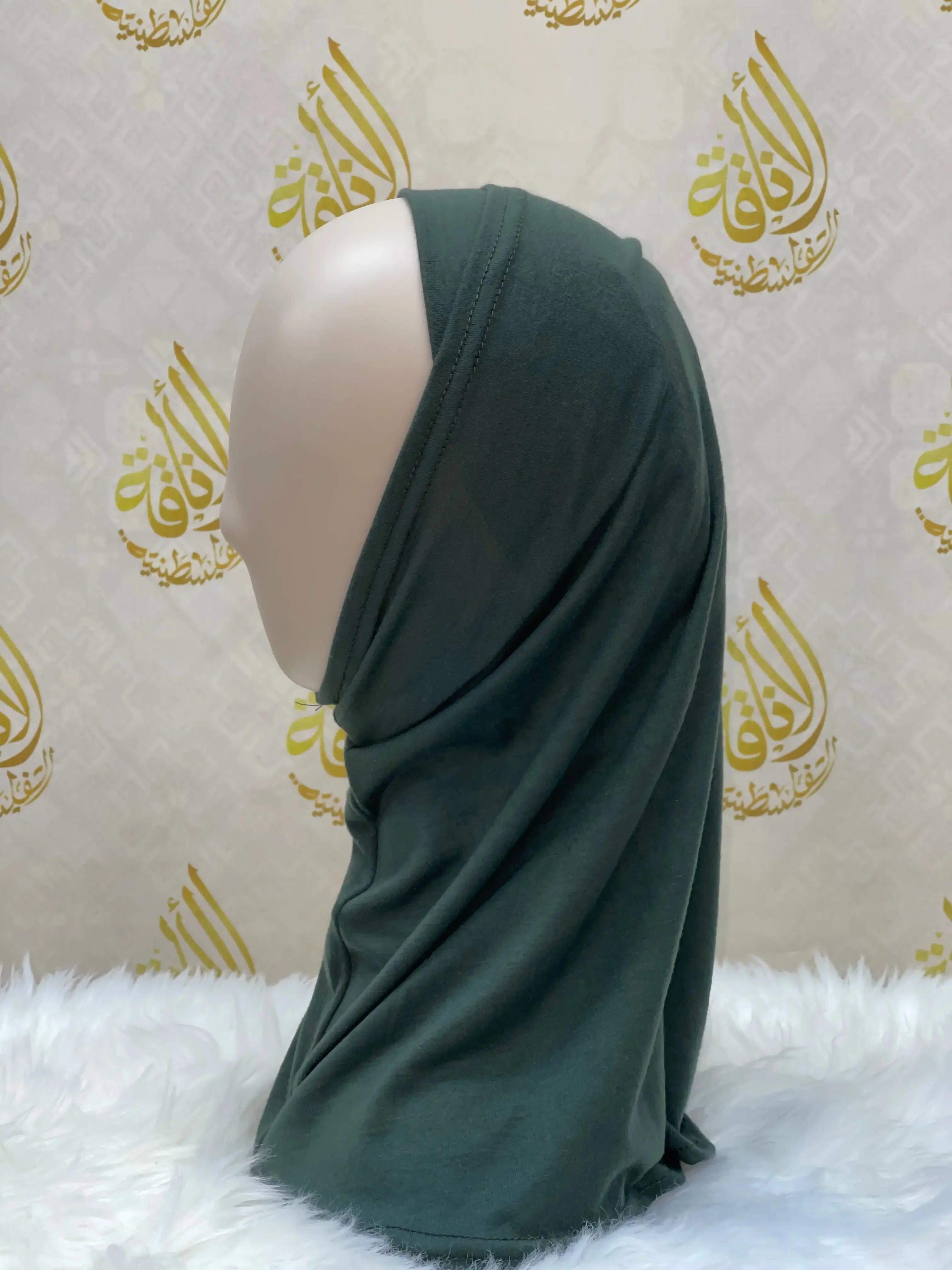 Palestinian Elegance dark green cotton hijab for women displayed on mannequin side view