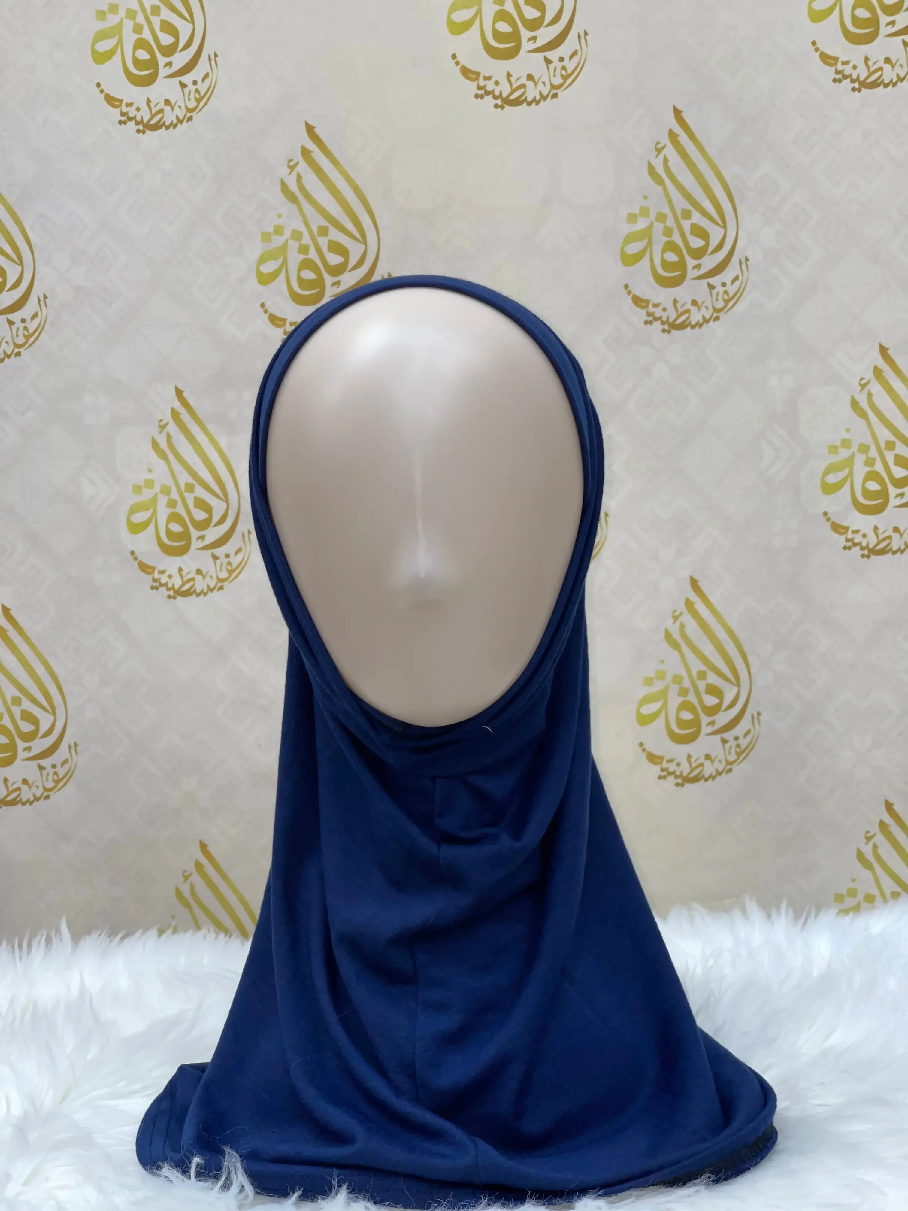 Palestinian Elegance navy blue cotton hijab for women displayed on mannequin with white furry surface