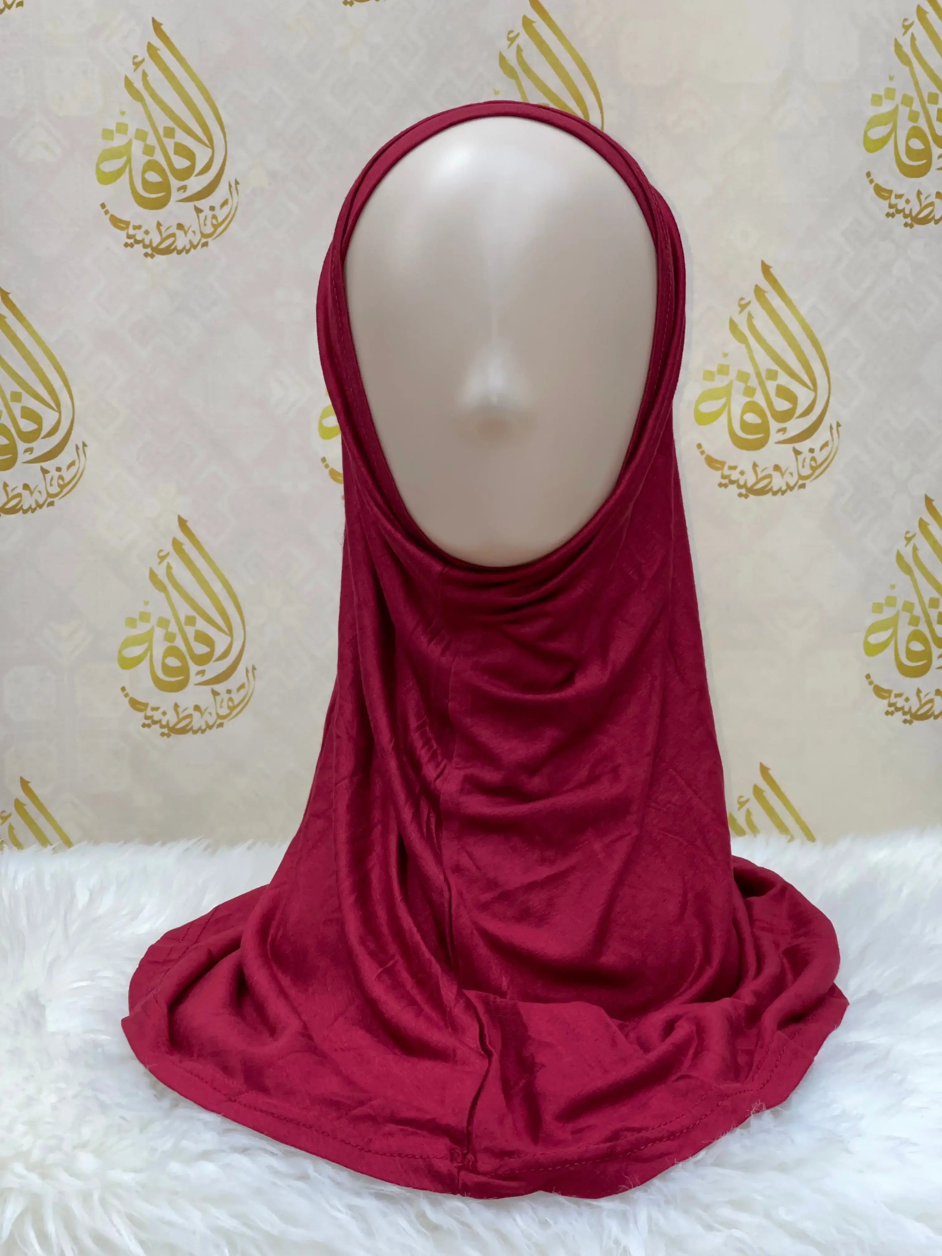 Palestinian Elegance maroon cotton hijab for women draped on mannequin head with smooth fabric texture