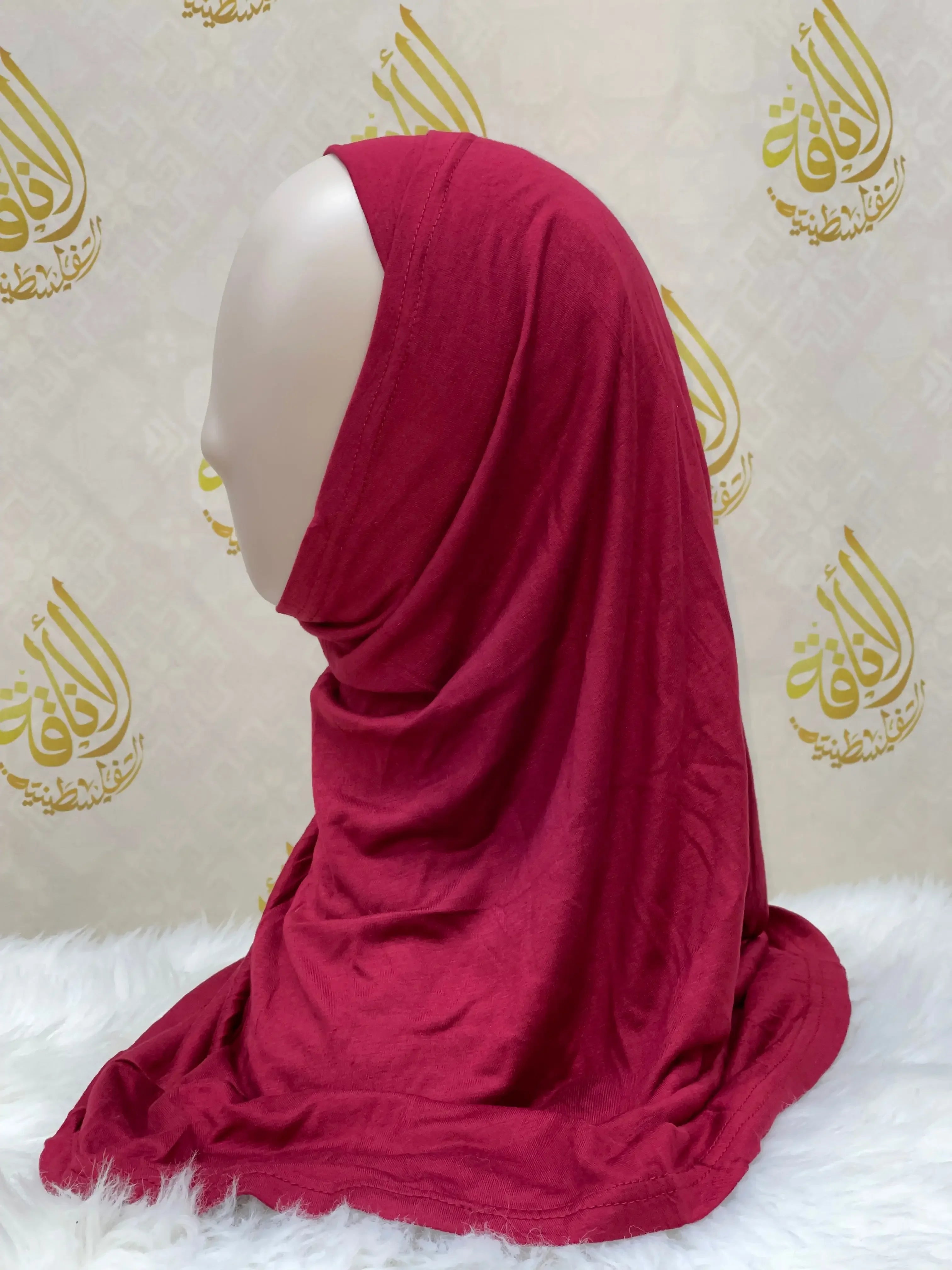 Palestinian Elegance cotton hijab for women in deep red displayed on mannequin with draped style