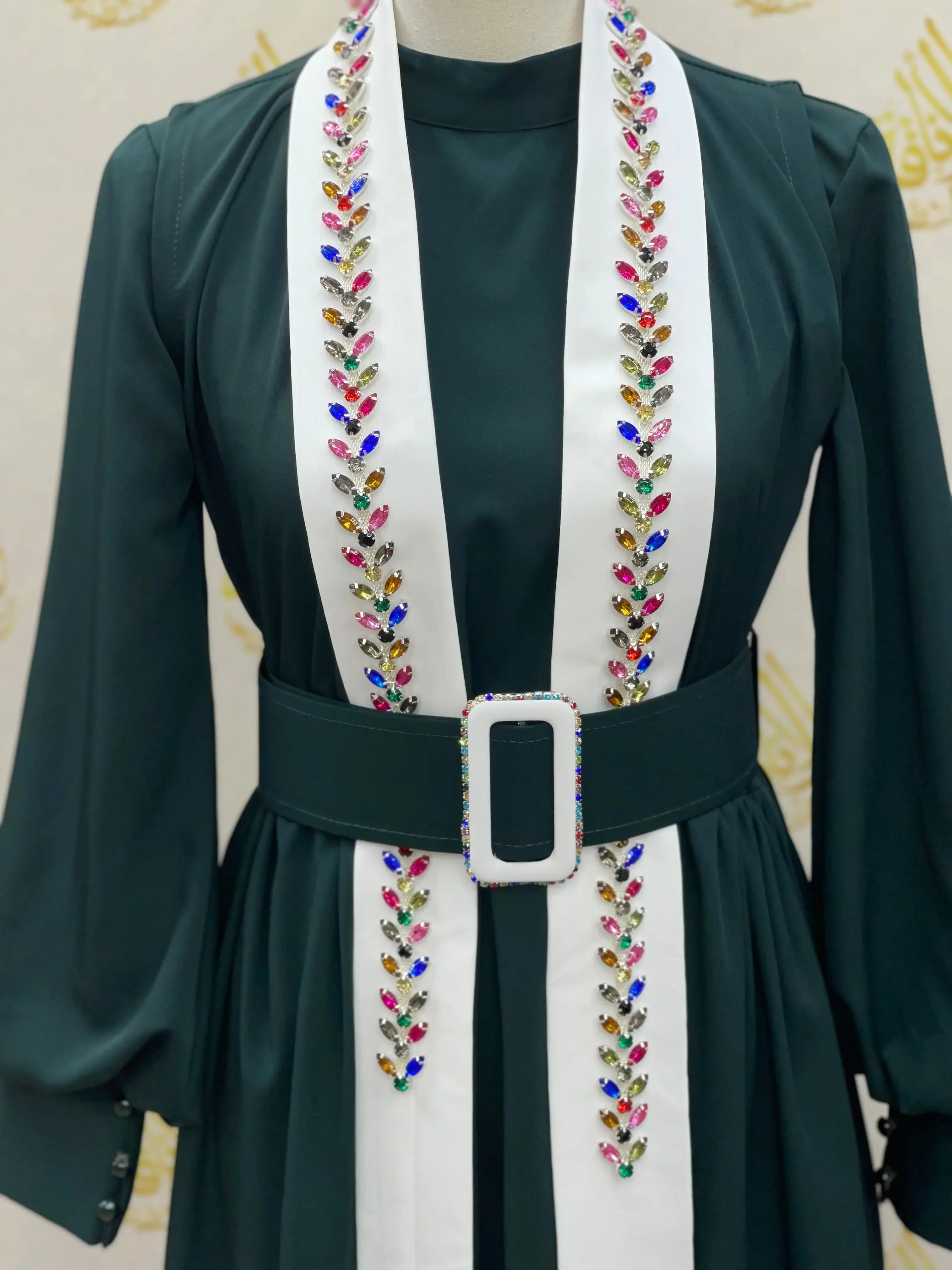 Palestinian Elegance crystal kaftan dress in dark fabric with white embellished panels and a matching belt