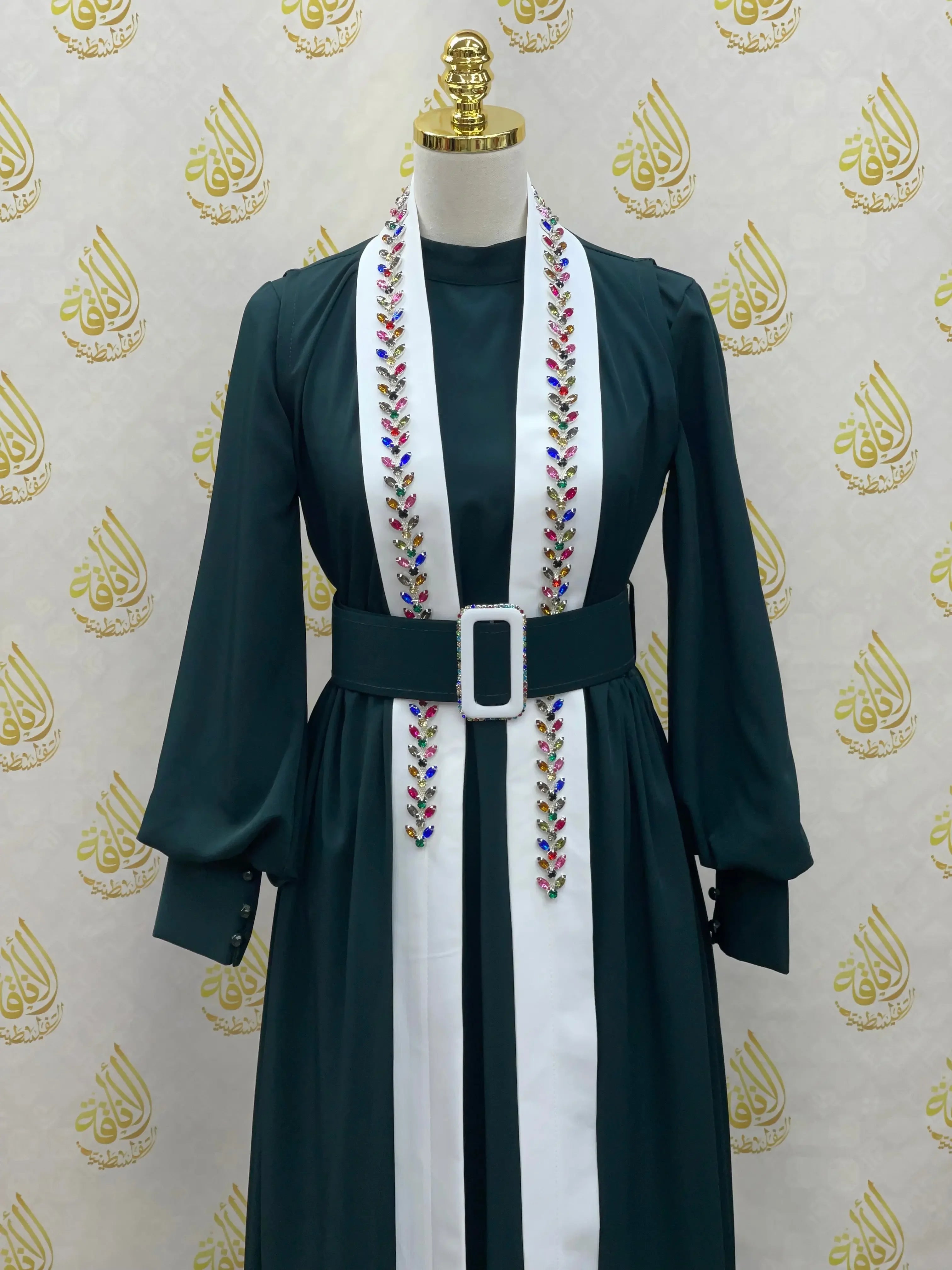 Palestinian Elegance crystal kaftan dress in dark green with long sleeves and embroidered white panel