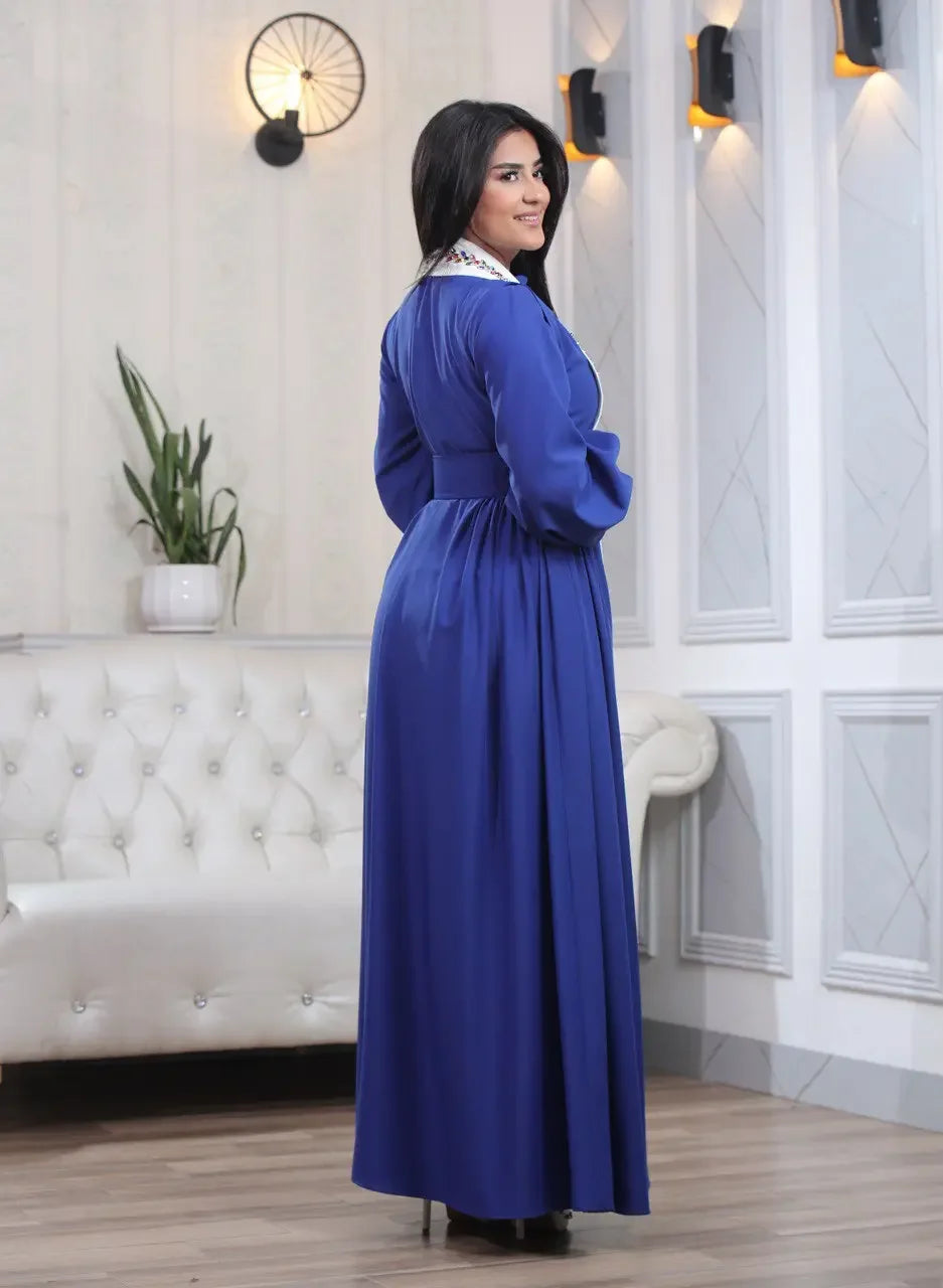 Palestinian Elegance blue crystal kaftan dress with long sleeves and detailed collar on woman