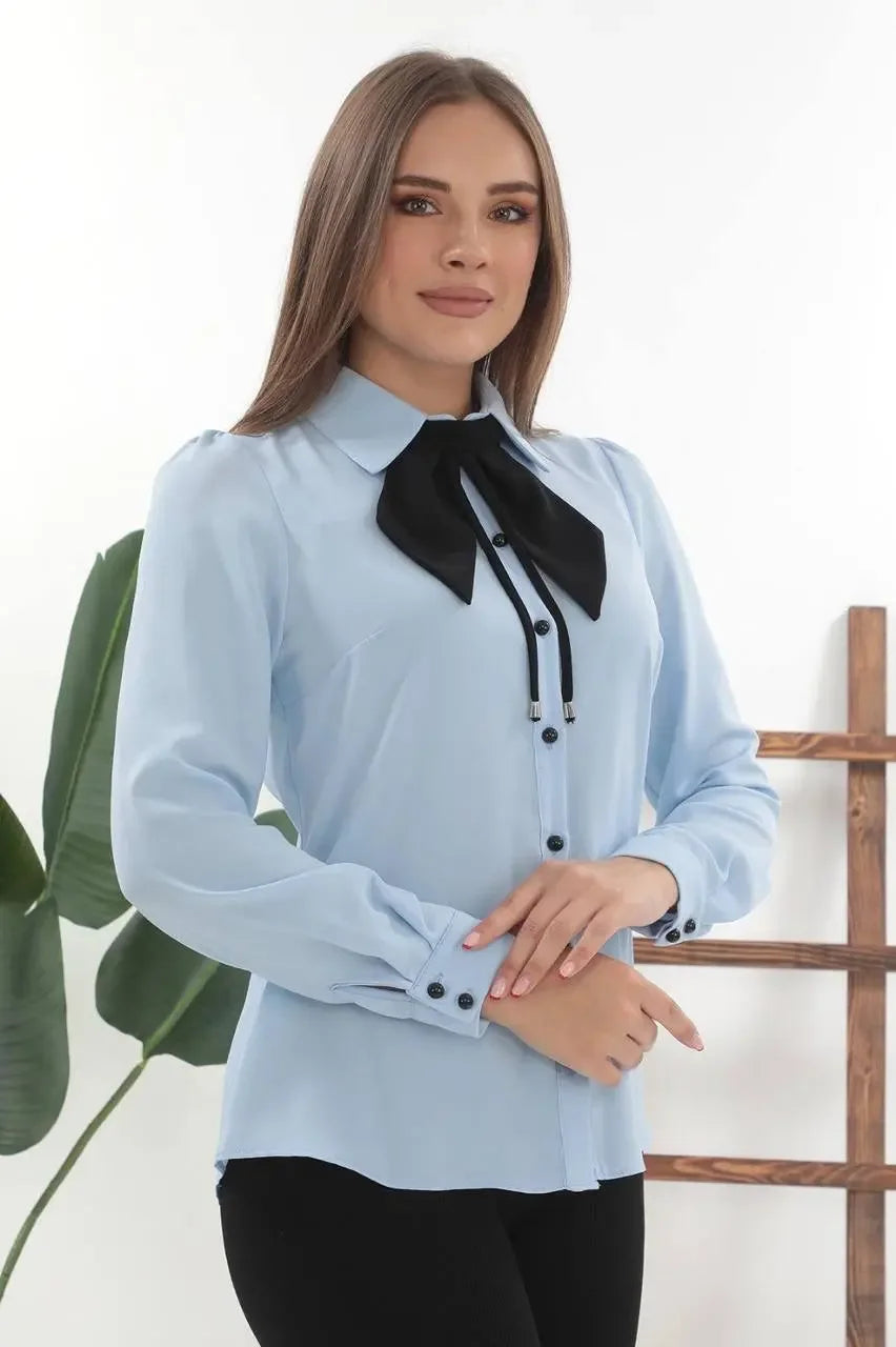 Light blue elegant bow tie blouse with long sleeves and black bow detail by Palestinian Elegance