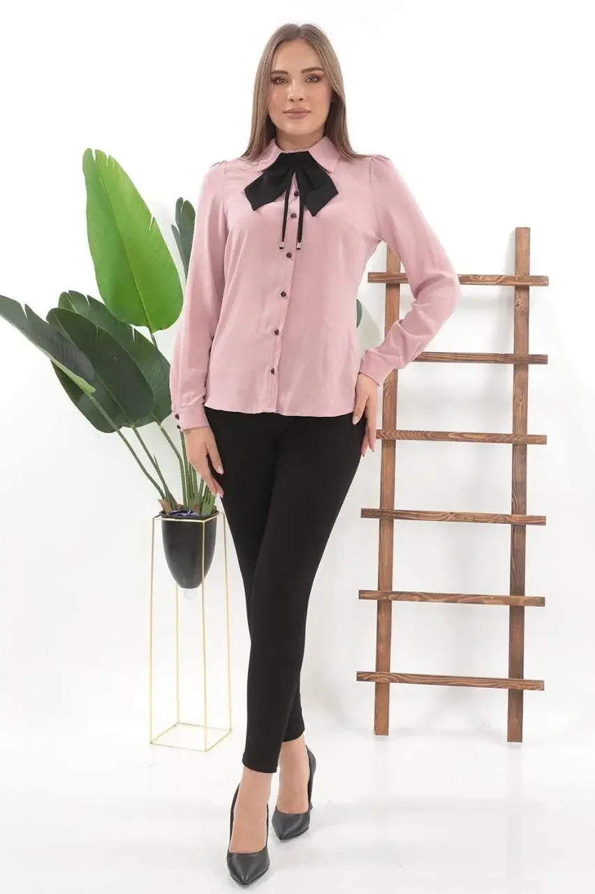 Palestinian Elegance elegant bow tie blouse in pink worn with black pants and heels