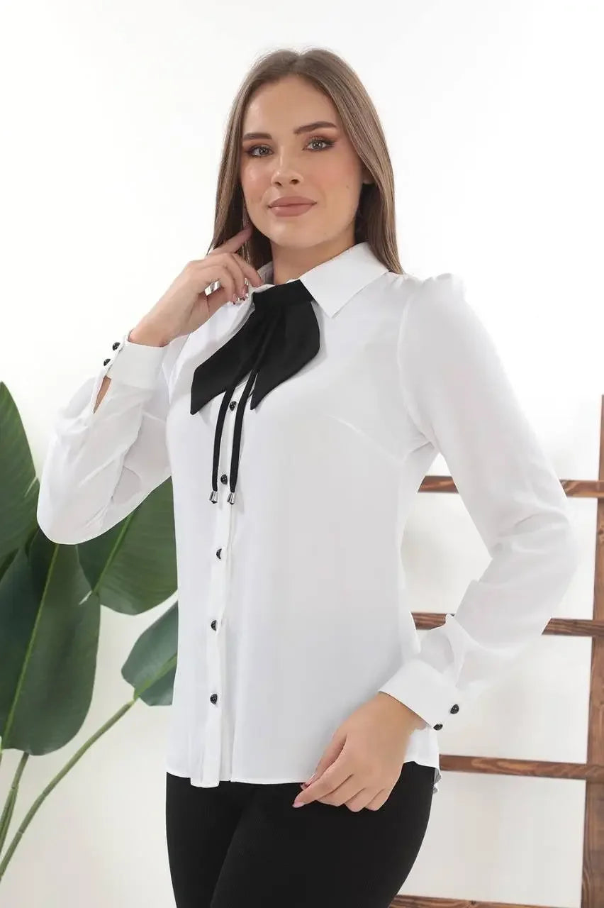 Palestinian Elegance elegant bow tie blouse in white with black bow detail and buttoned cuffs