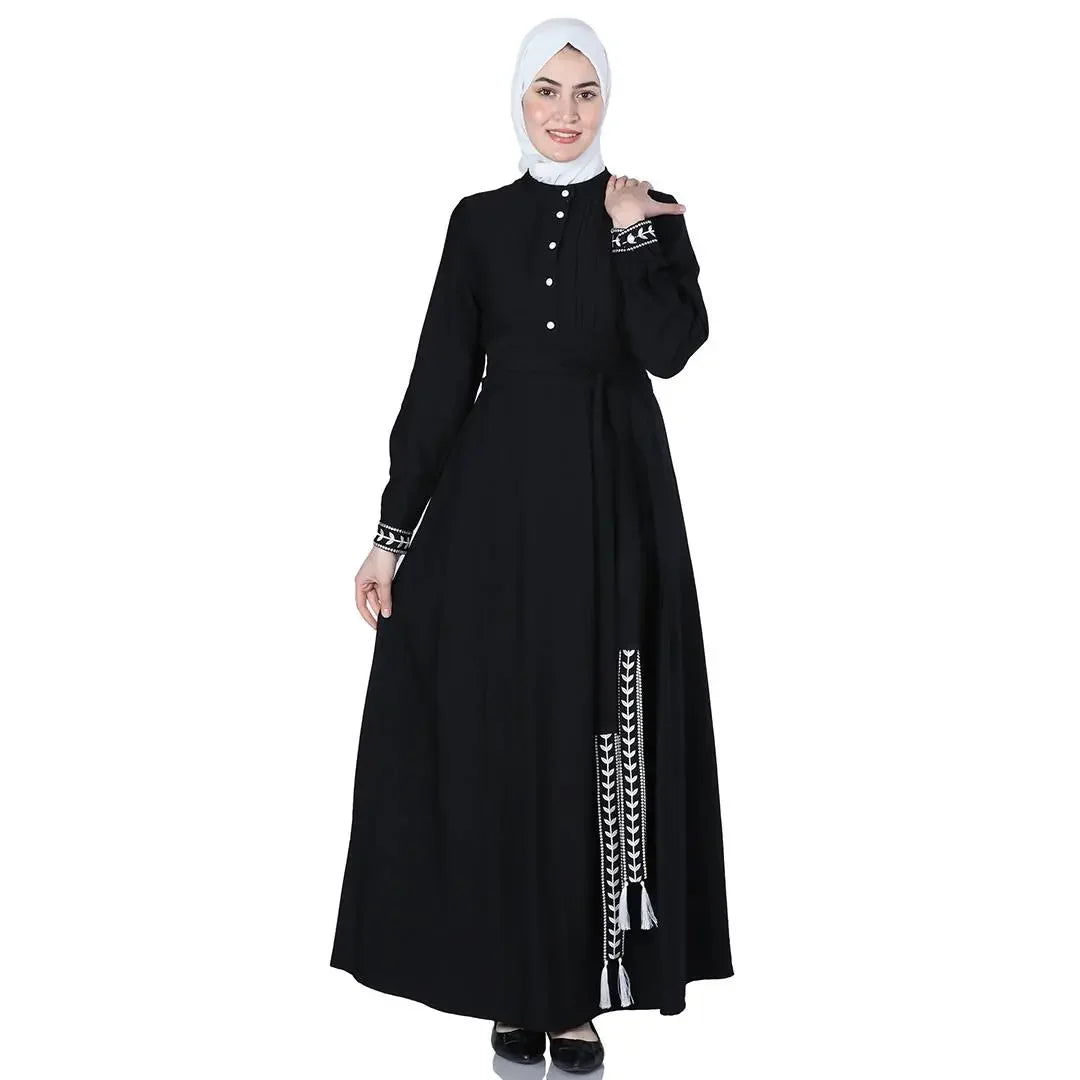 Palestinian Elegance black modest dress with white embroidery, styled as an elegant modest blue dress alternative