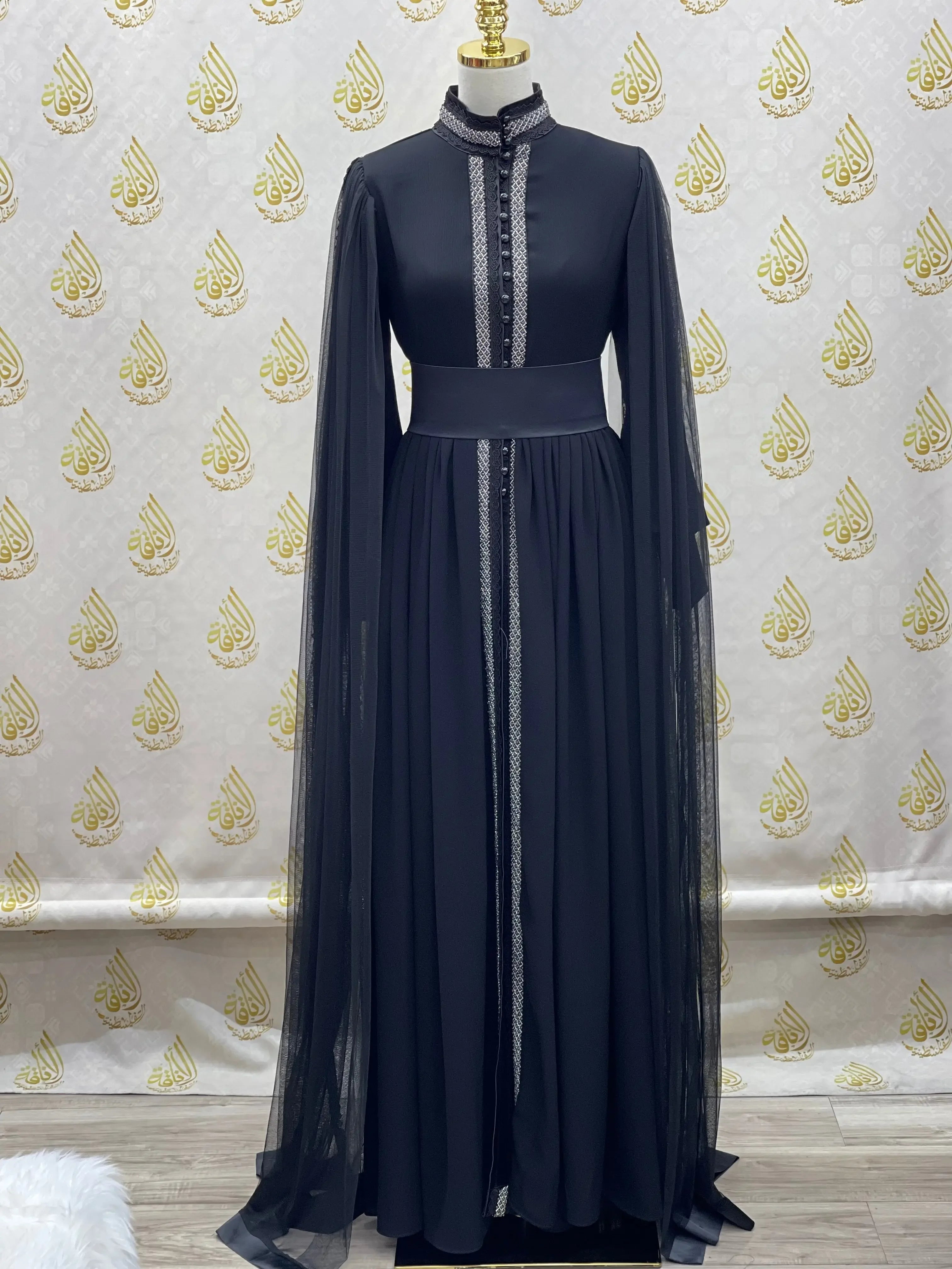 Palestinian Elegance elegant modest formal dress in black with long sheer sleeves and intricate front detailing