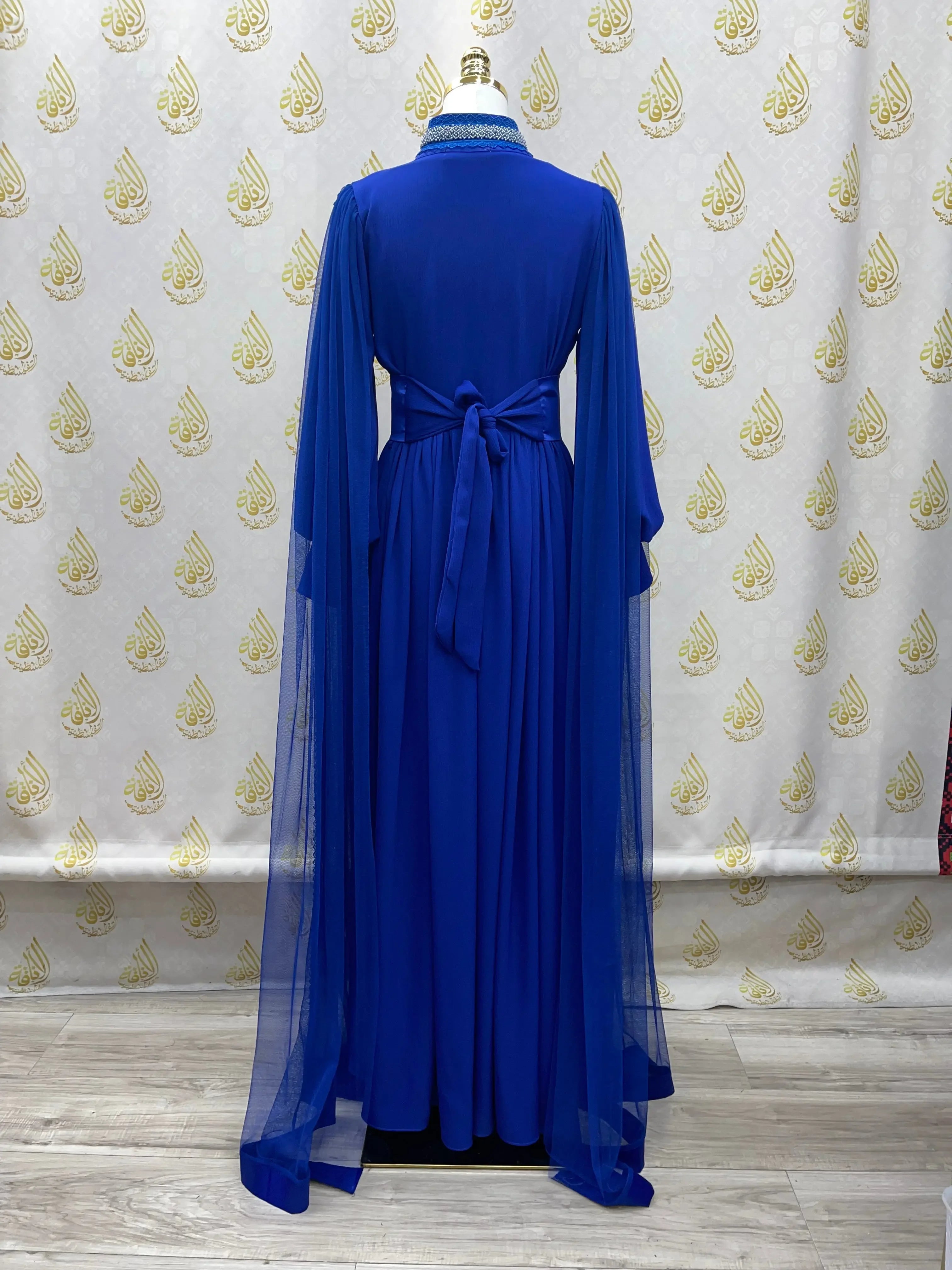 Palestinian Elegance royal blue elegant modest formal dress with long sheer sleeves and waist tie