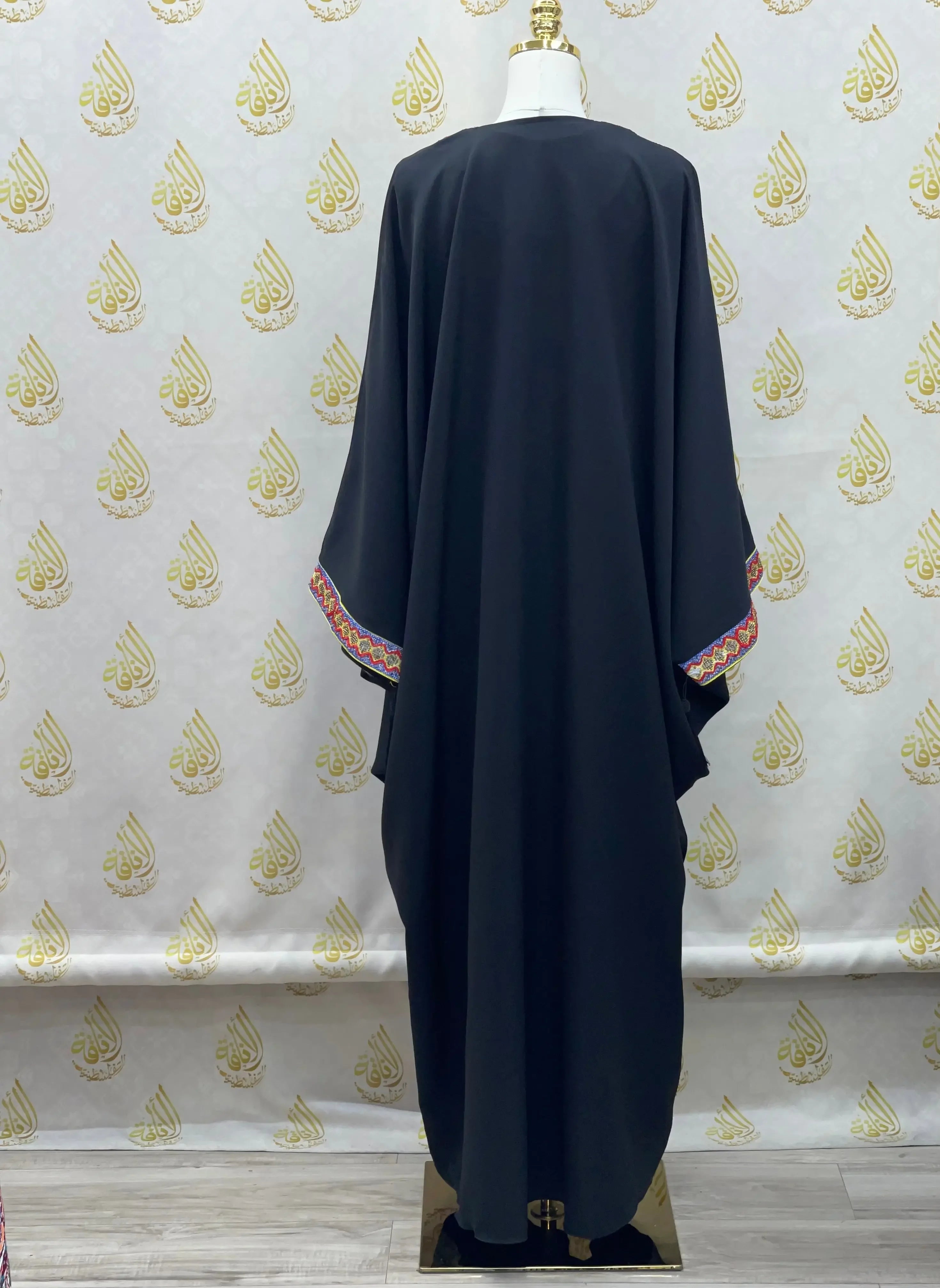 Palestinian Elegance embroidered abaya dress in black with colorful embroidery on sleeve edges