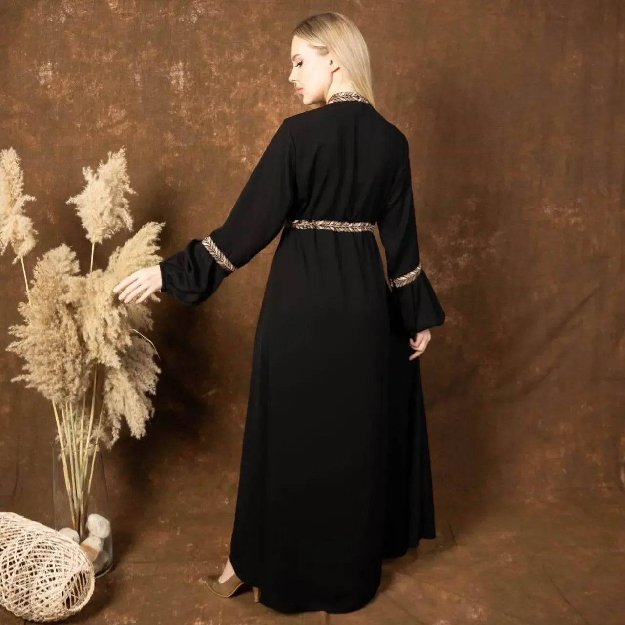 Palestinian Elegance embroidered abaya dress in black with detailed embroidery on cuffs and waist from back view