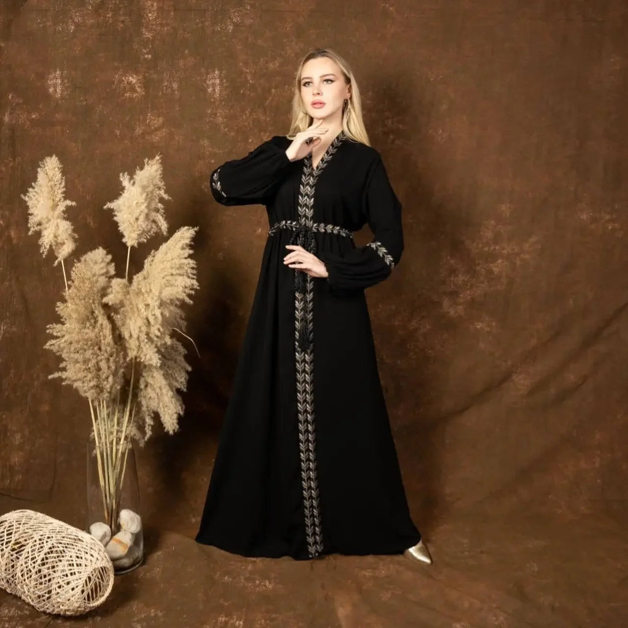 Palestinian Elegance black embroidered abaya dress with silver detailing worn by woman