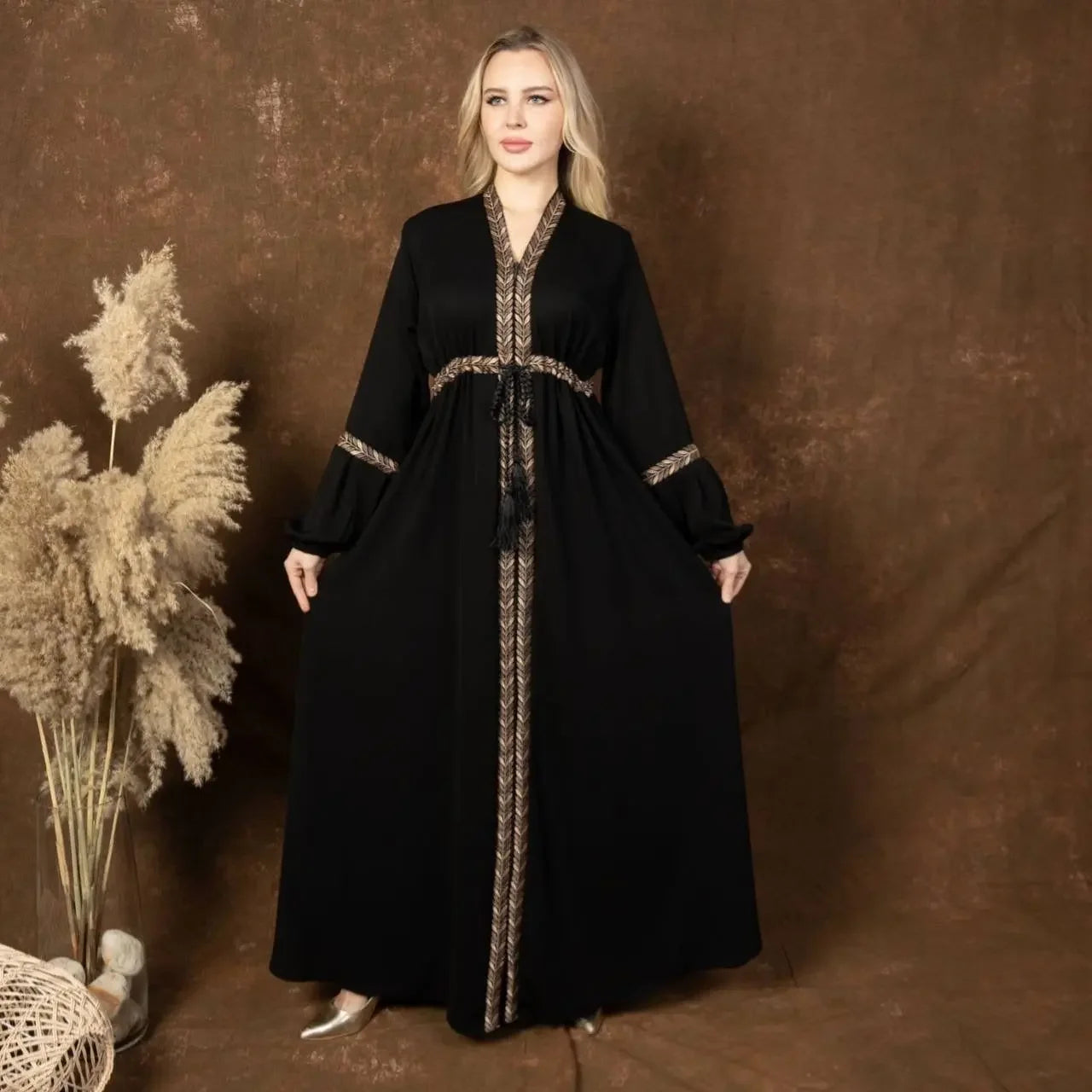 Palestinian Elegance black embroidered abaya dress with detailed gold trim and long flowing sleeves