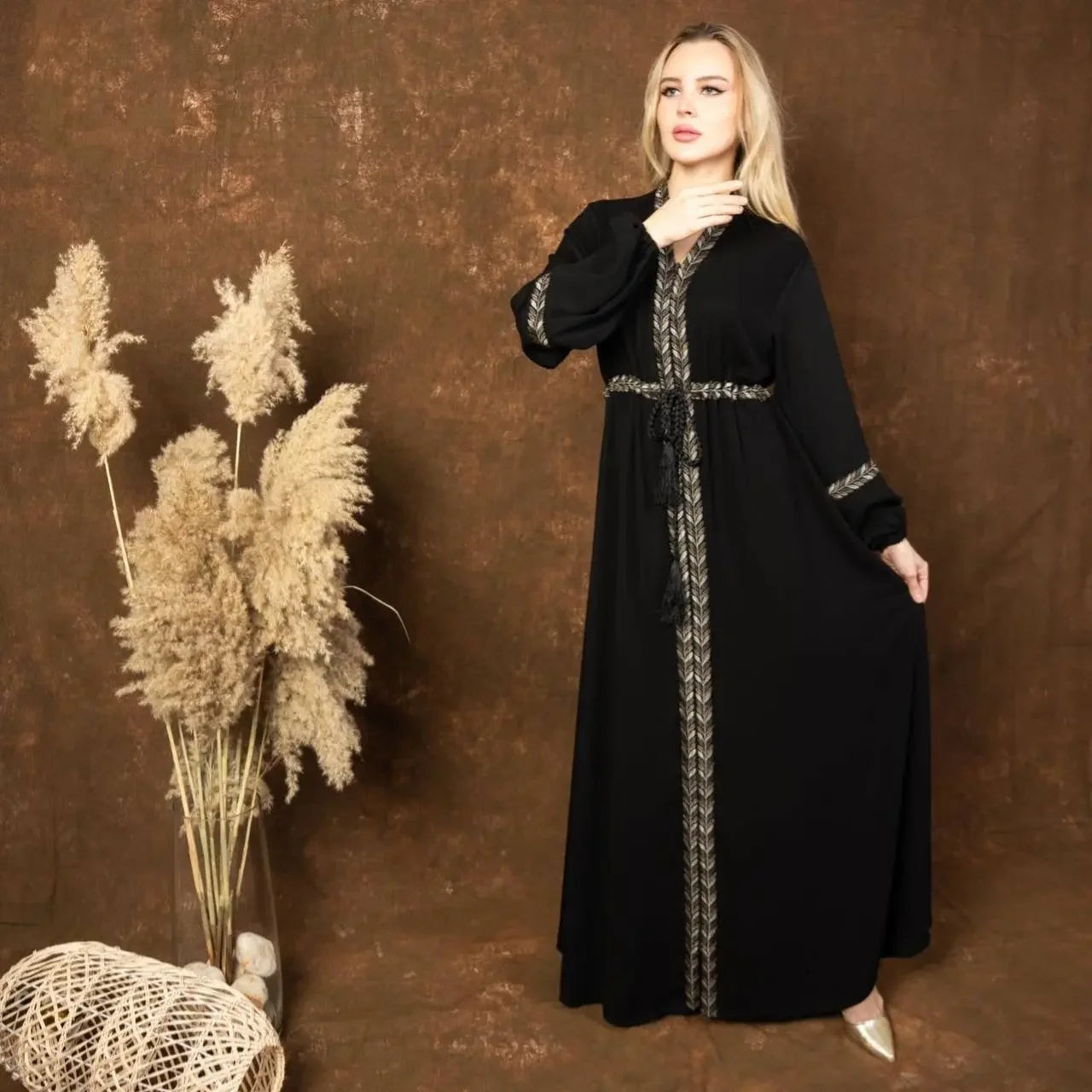 Palestinian Elegance black embroidered abaya dress with intricate silver detailing along front and sleeves