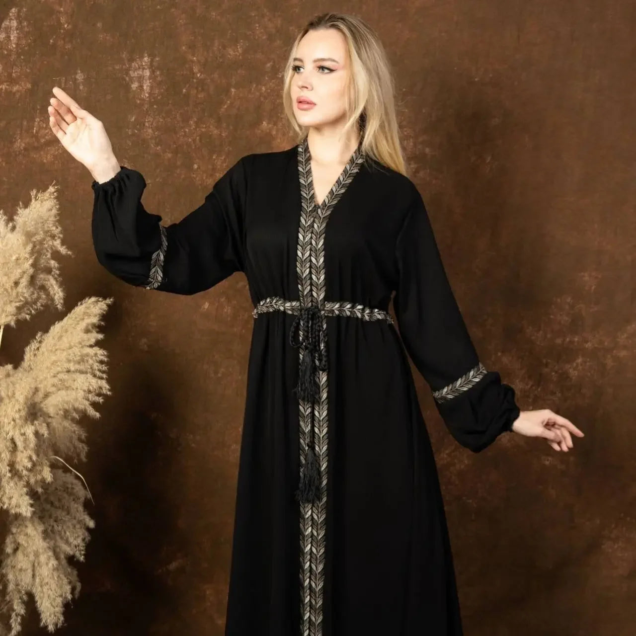 Palestinian Elegance black embroidered abaya dress with detailed silver stitching and tassel belt
