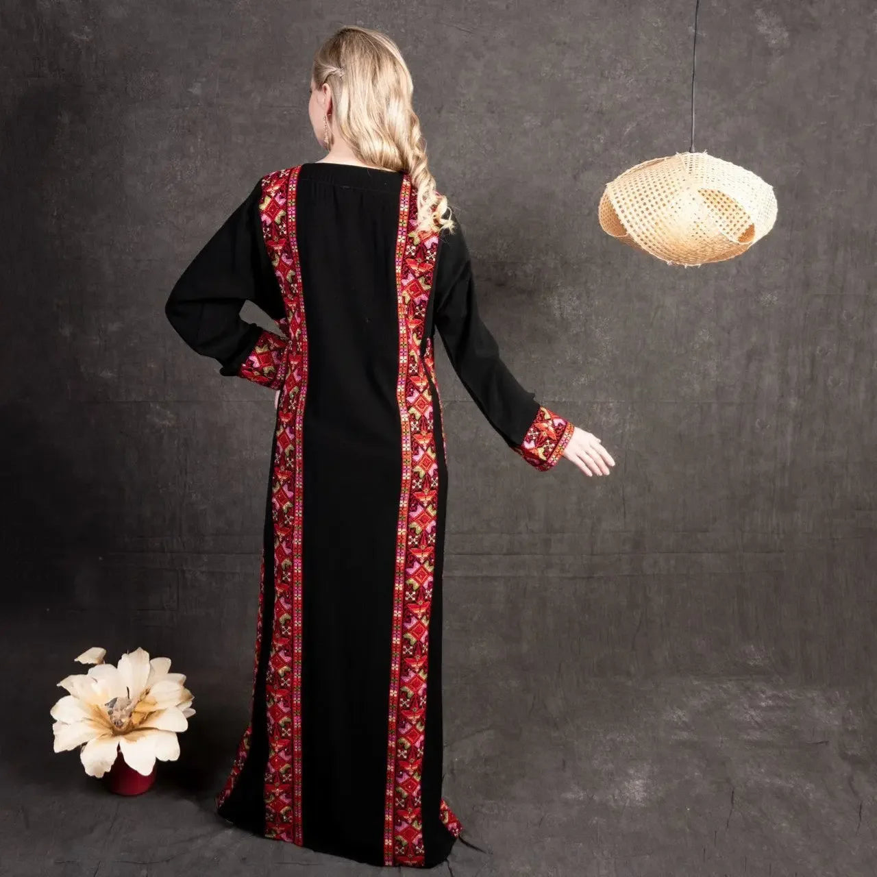 Black embroidered abaya dress with red and pink traditional embroidery details from Palestinian Elegance