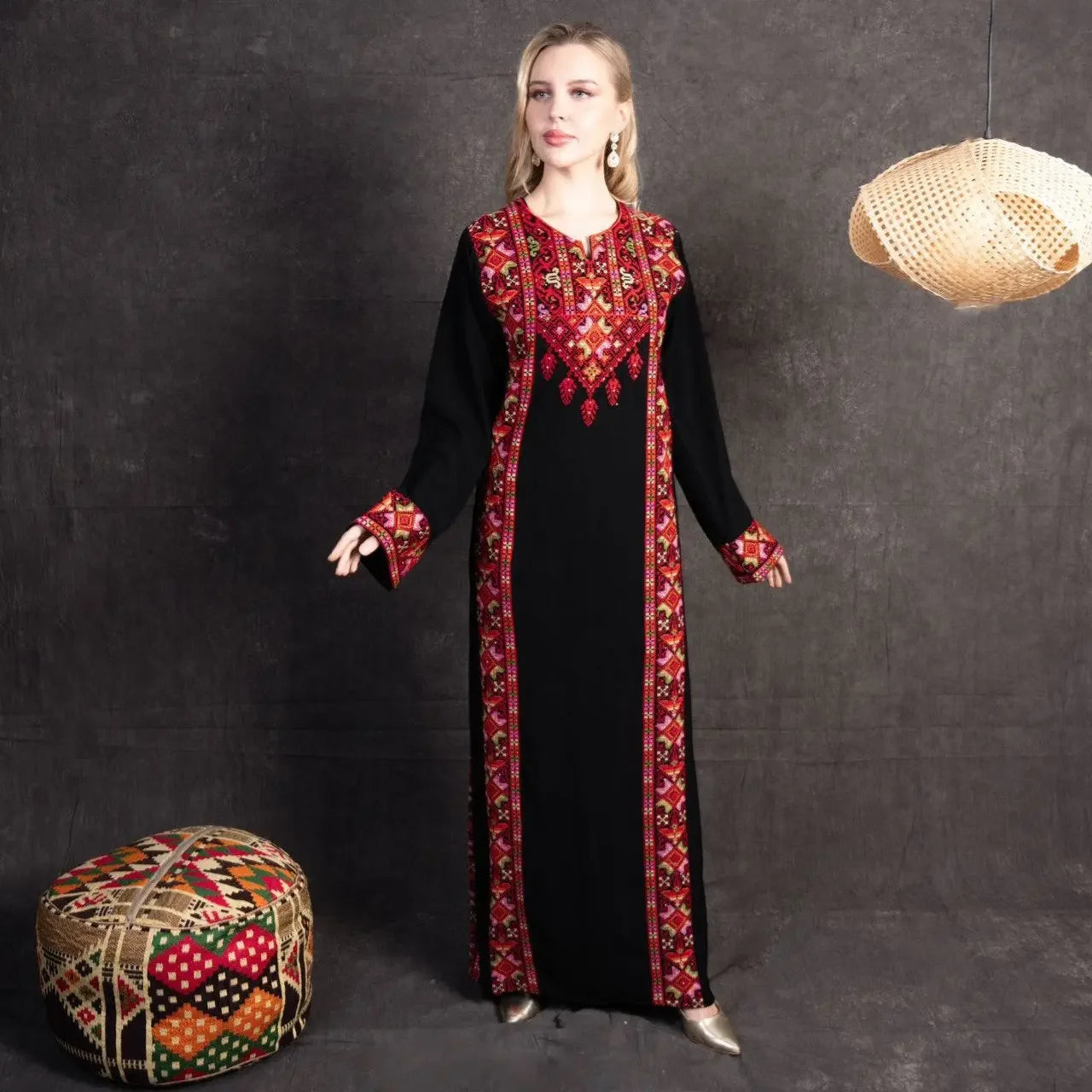 Palestinian Elegance embroidered abaya dress in black with vibrant red and gold traditional embroidery