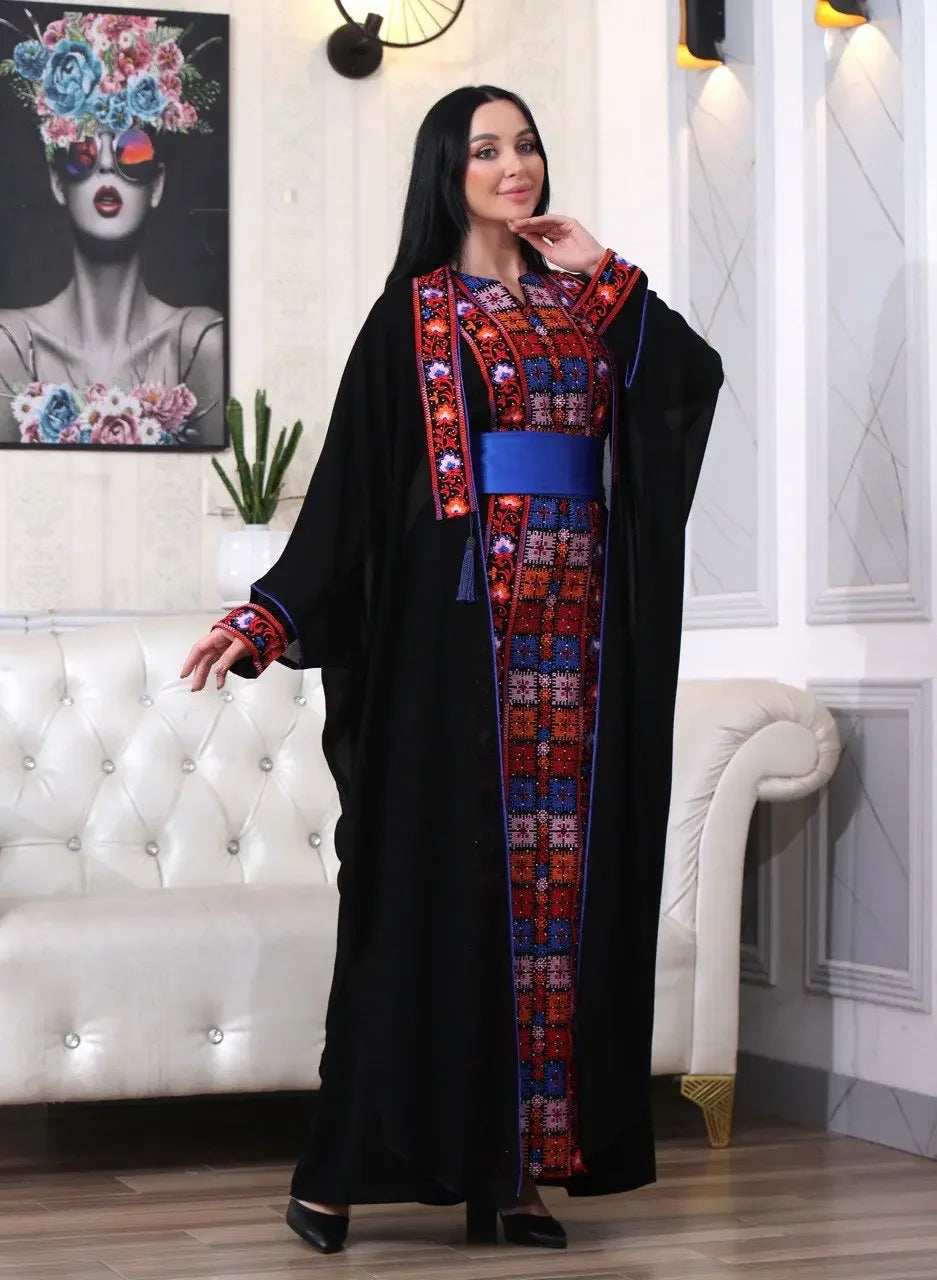 Elegant embroidered abaya with cardigan by Palestinian Elegance featuring intricate red and blue embroidery on black kaftan