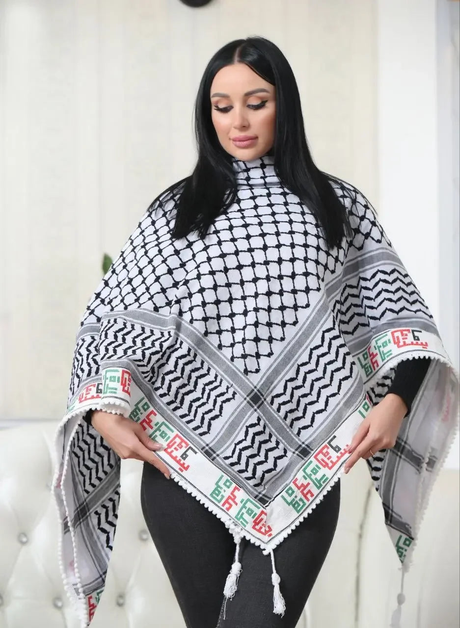 Woman wearing a black and white embroidered kuffiyeh scarf with geometric patterns and tassels