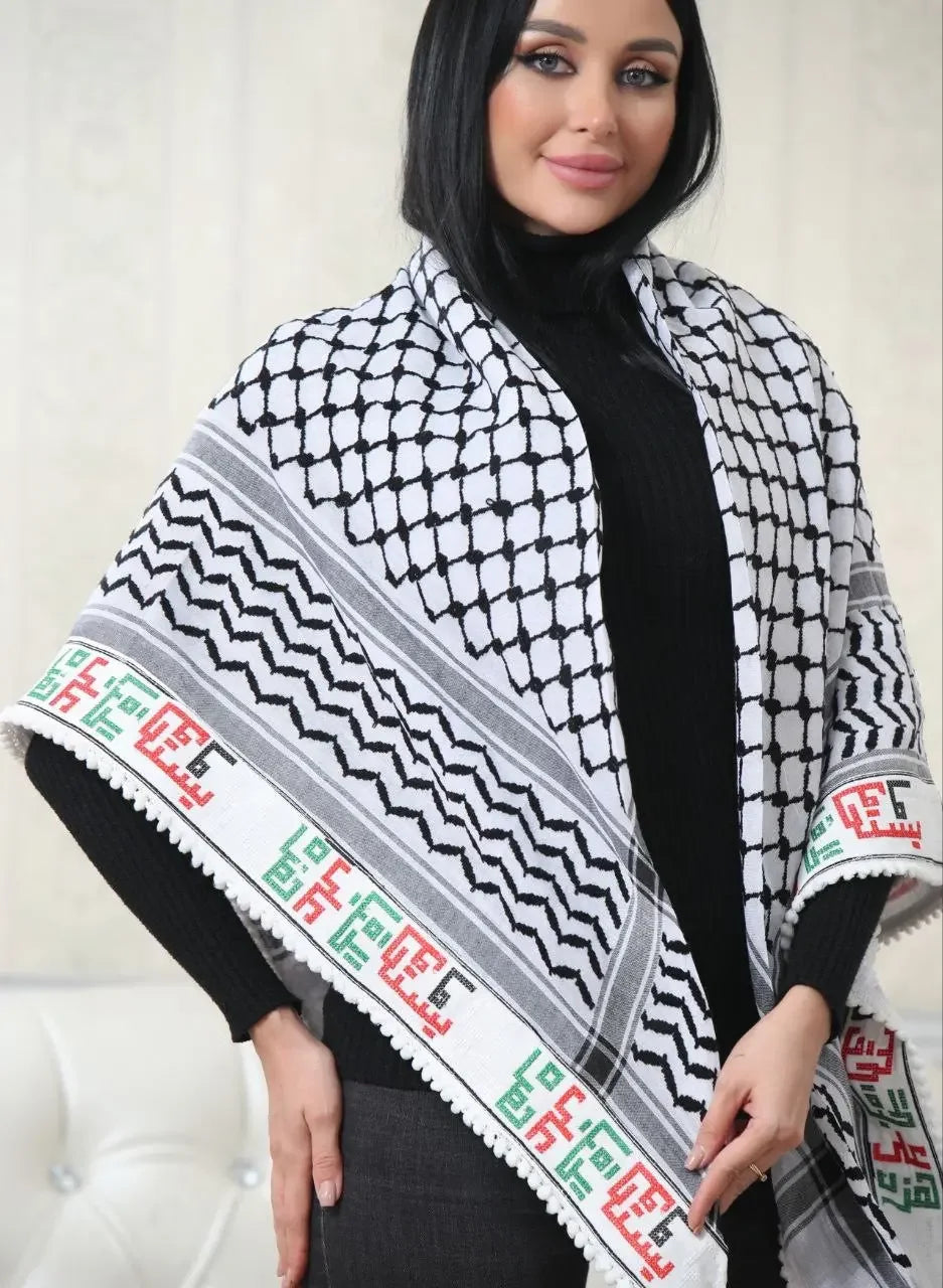 Woman wearing a black and white embroidered kuffiyeh scarf with traditional Palestinian patterns