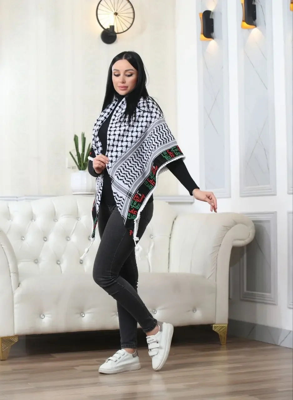 Woman wearing Palestinian Elegance embroidered kuffiyeh scarf with traditional black and white patterns indoors