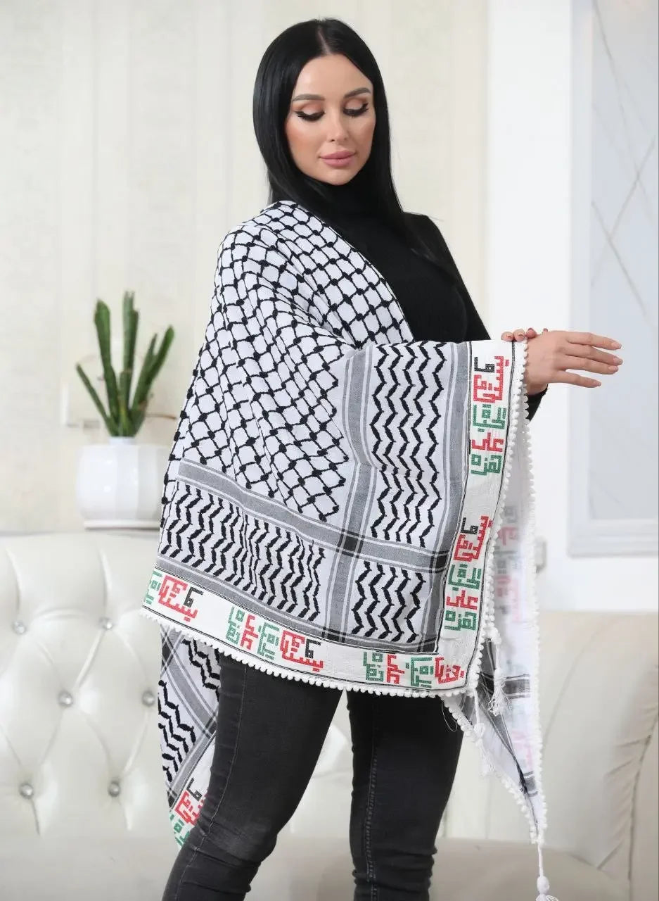 Woman wearing embroidered kuffiyeh scarf with traditional black and white pattern and colorful border