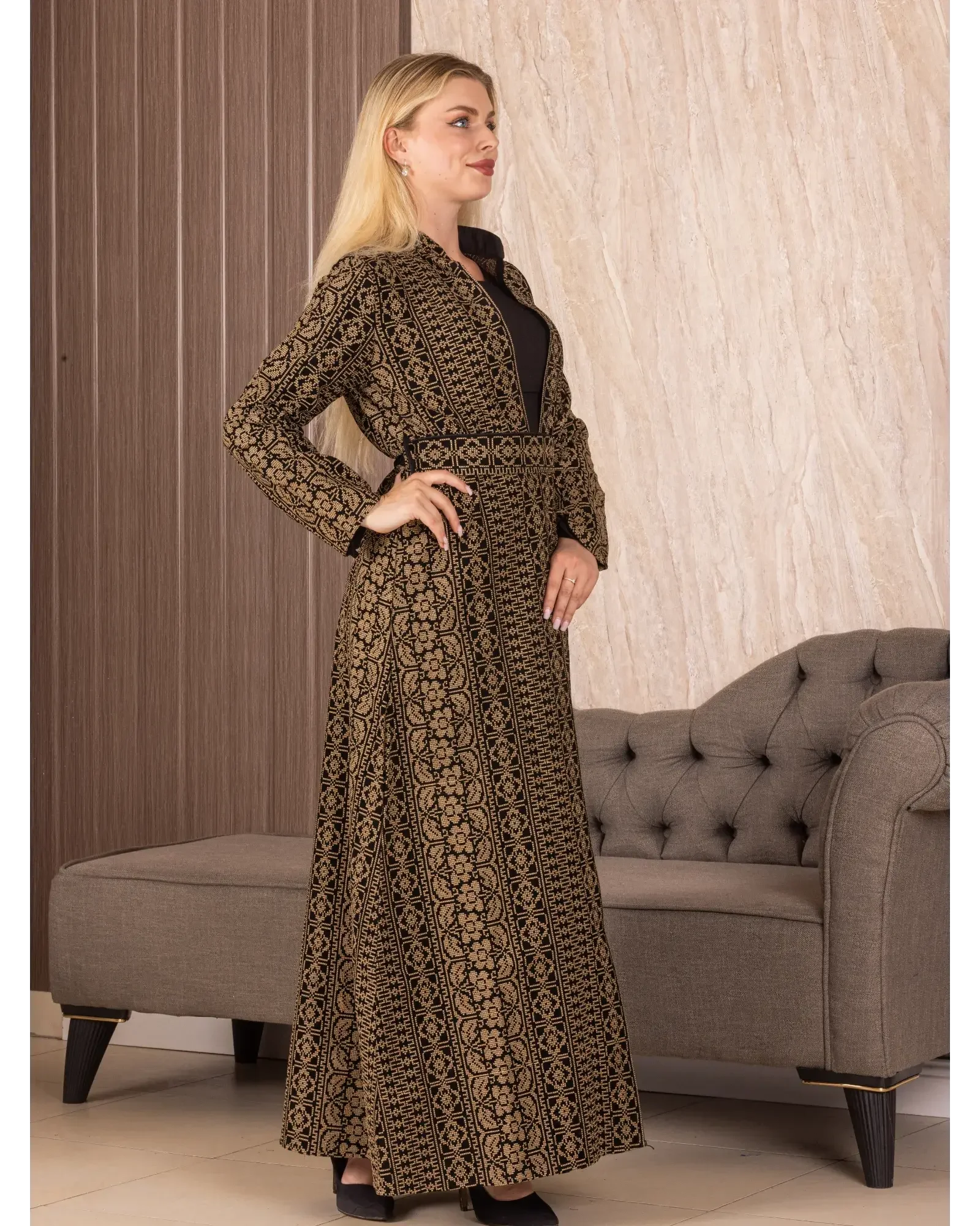 Palestinian Elegance embroidered long cardigan with intricate gold embroidery worn by model indoors