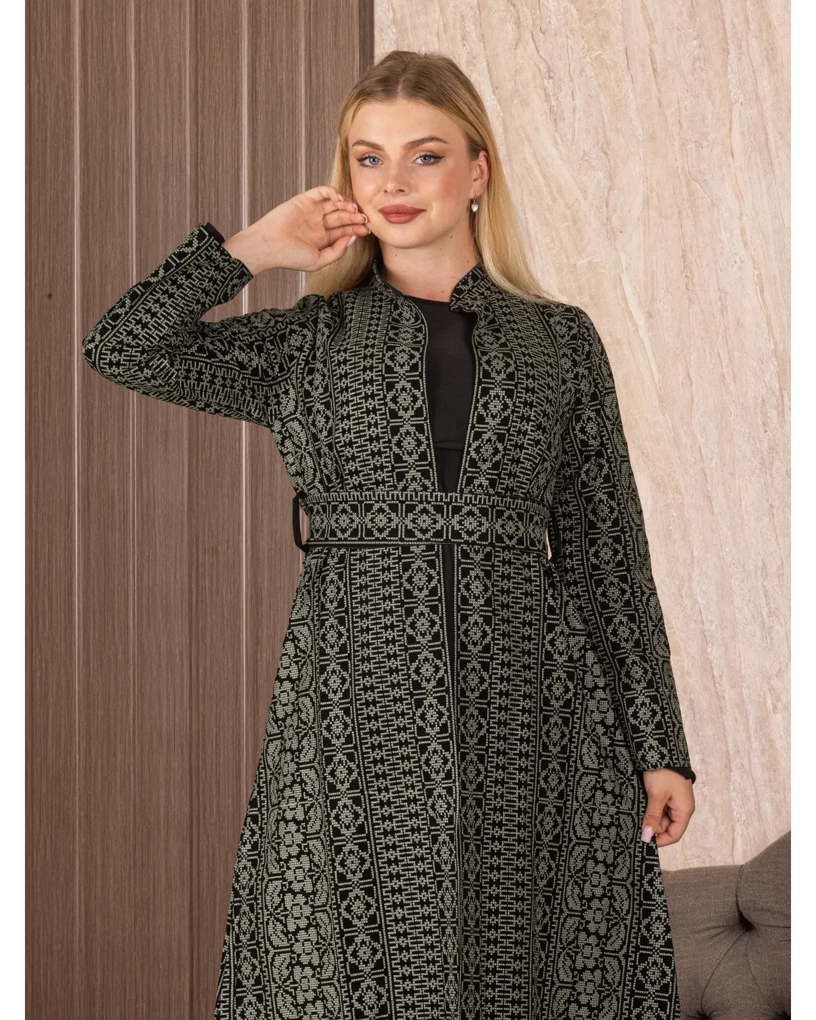 Palestinian Elegance black embroidered long cardigan with intricate geometric and floral patterns worn by a model