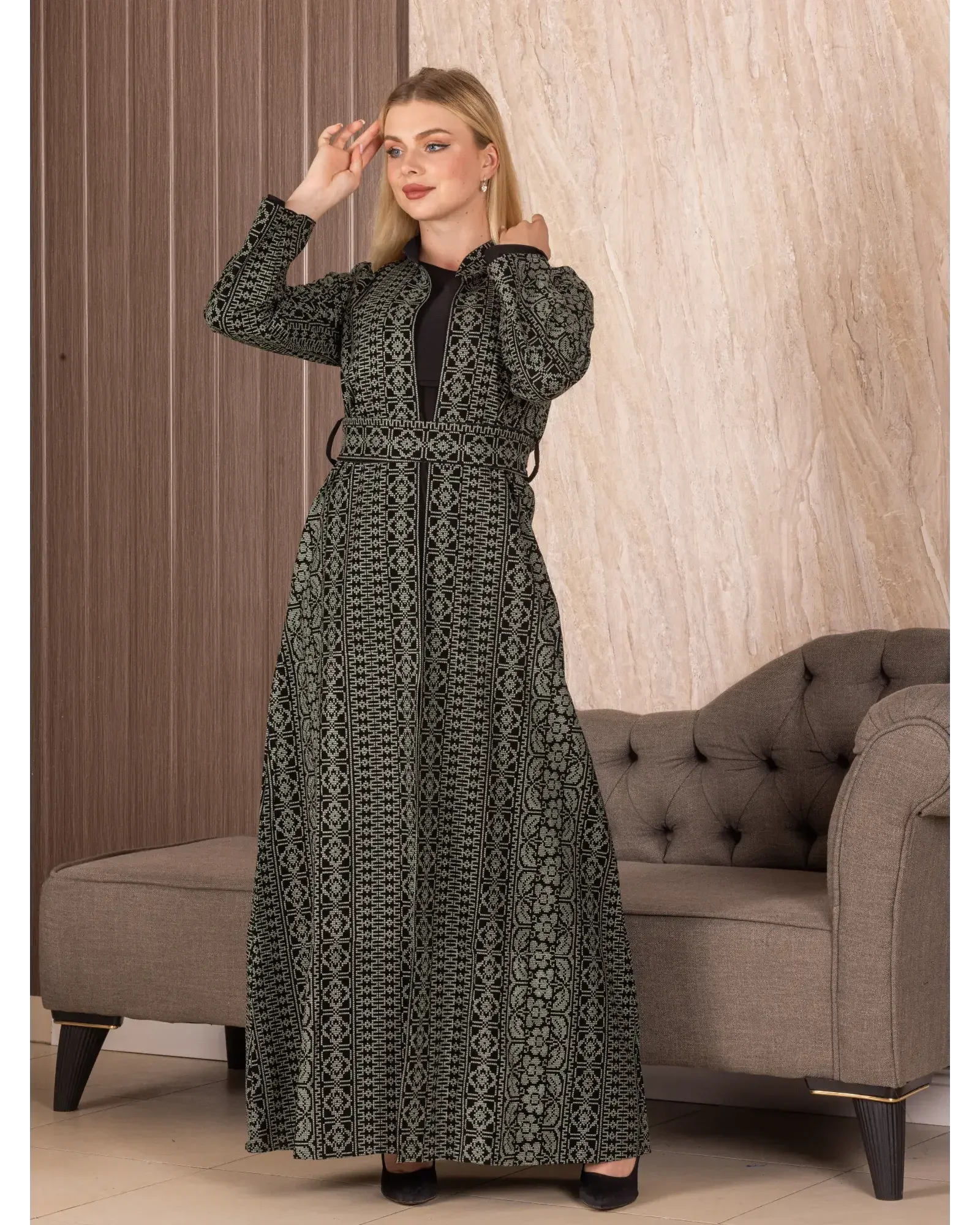 Palestinian Elegance embroidered long cardigan with detailed patterns worn by a woman indoors