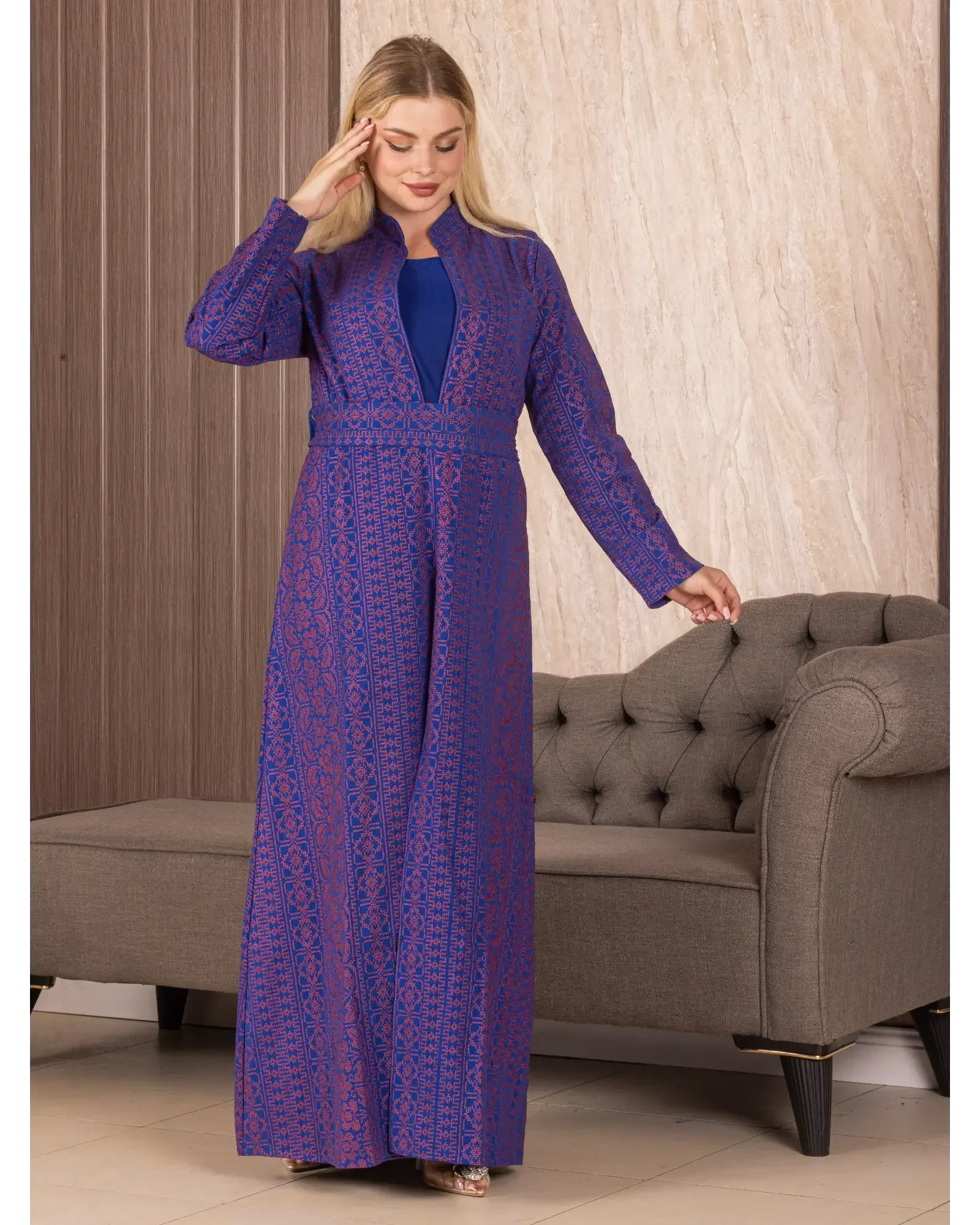 Woman wearing a purple embroidered long cardigan with intricate patterns from Palestinian Elegance
