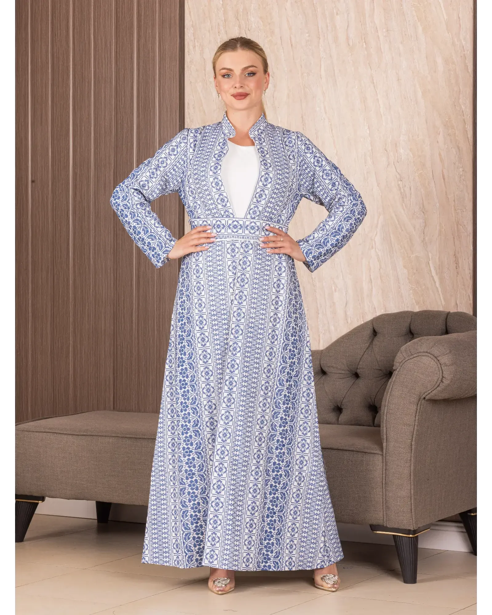 Palestinian Elegance embroidered long cardigan in blue and white geometric patterns worn by a woman