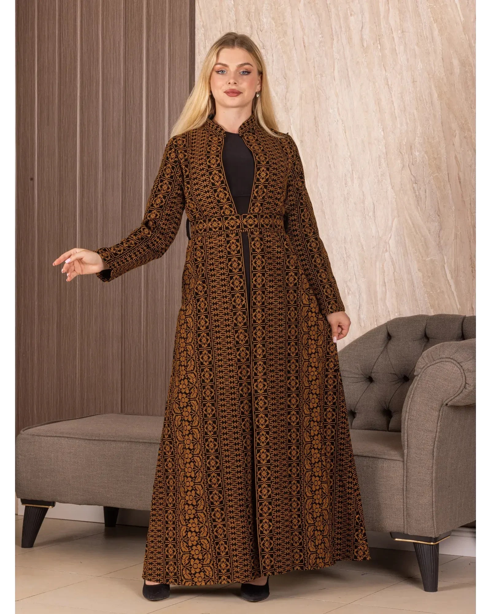 Palestinian Elegance embroidered long cardigan with intricate patterns worn by woman indoors